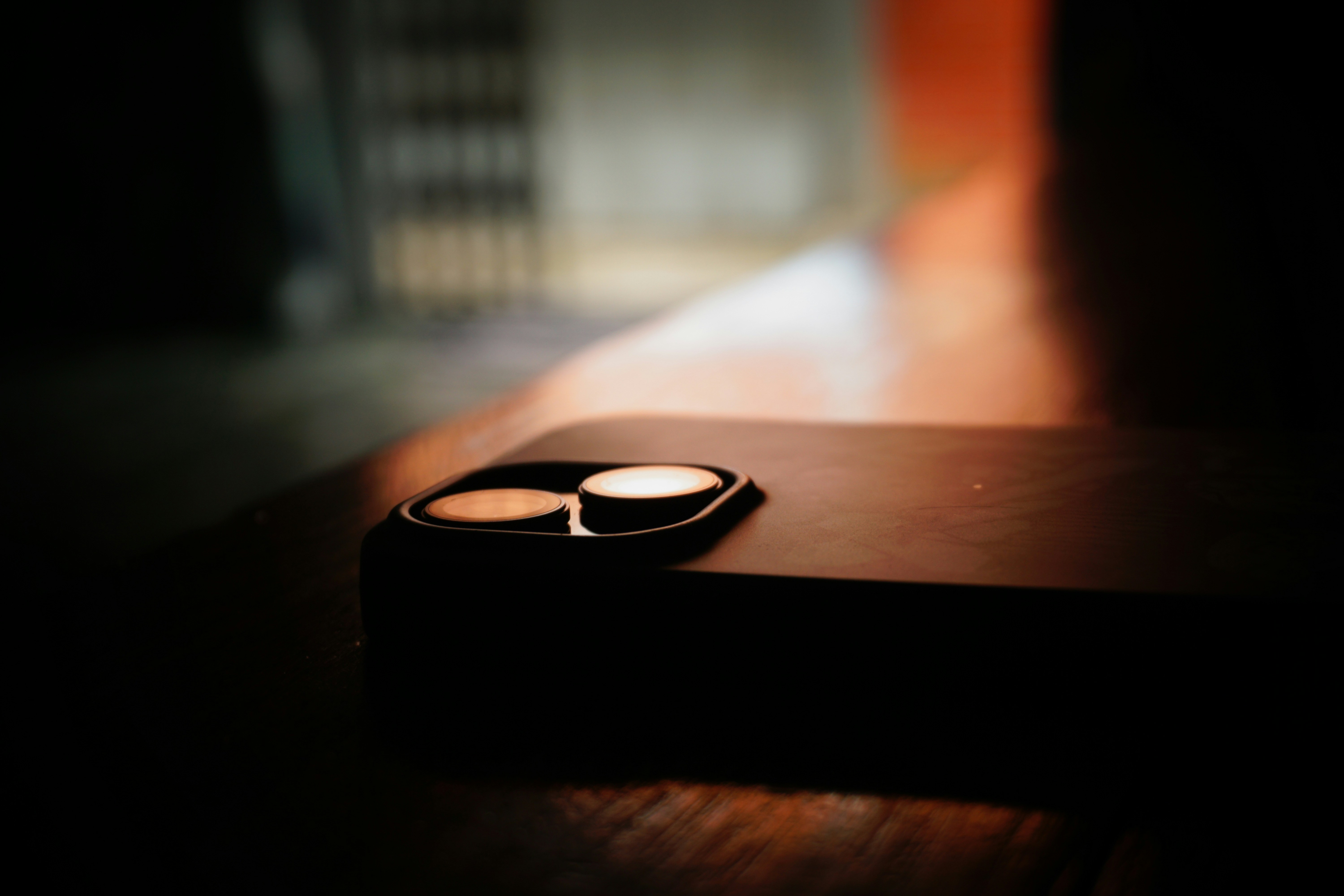 A cell phone sitting on top of a wooden table