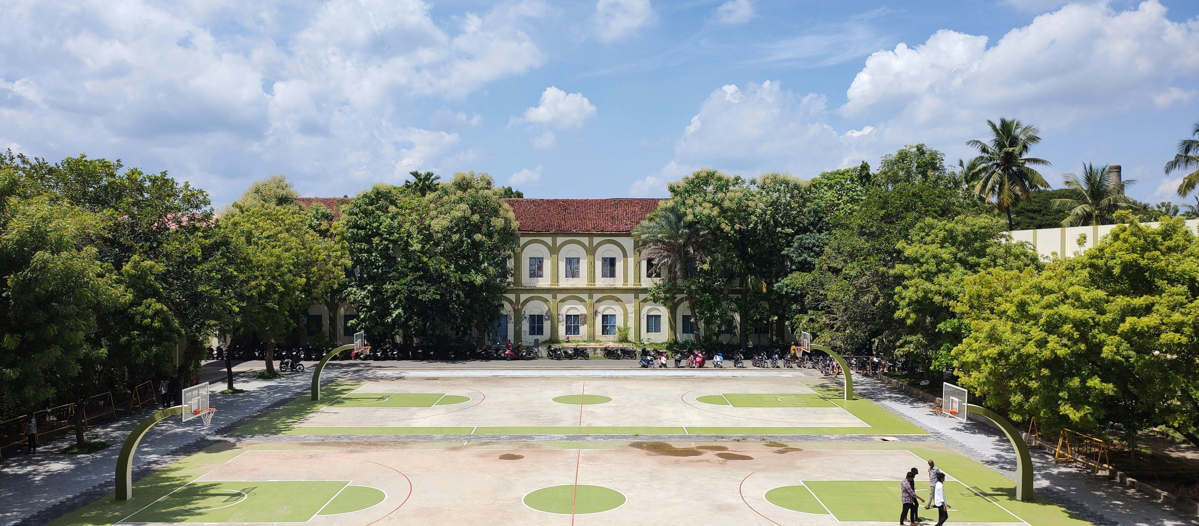 An aerial view of a large building surrounded by trees