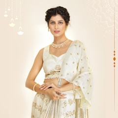 A woman wearing a white sari and a necklace