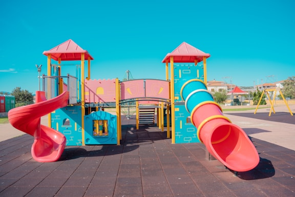 A playground with a slide and a play structure