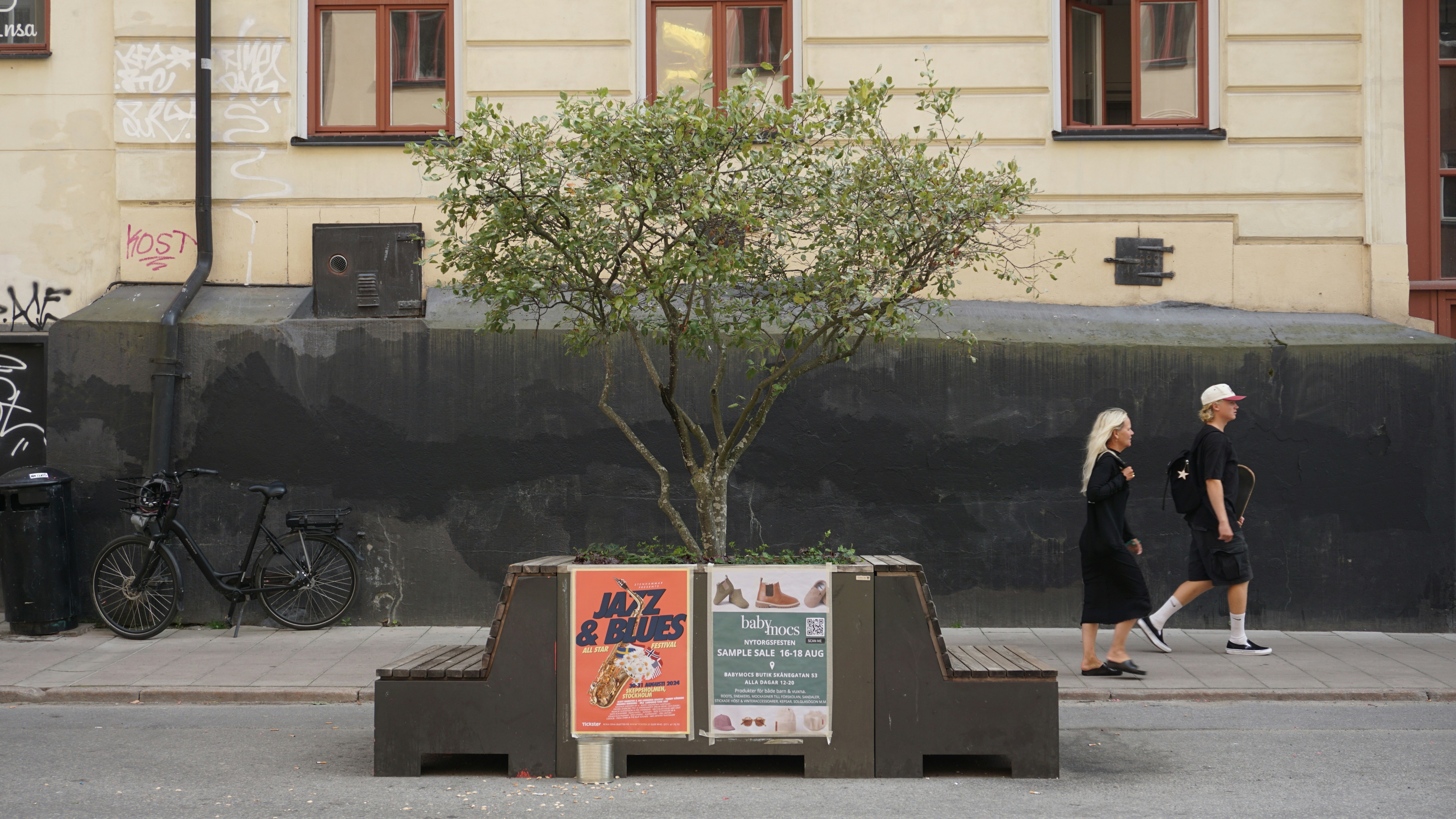 A man and a woman walking down a street, 