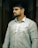 A man with a beard standing in a hallway
