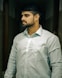 A man with a beard standing in a hallway