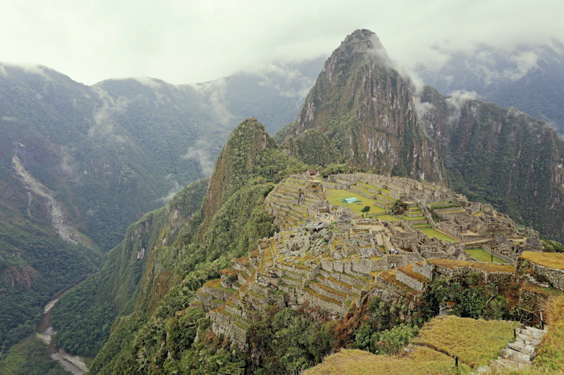 Huayna Picchu rising above the Machu Picchu citadel, terraces stepping down the ridge