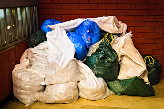 A pile of garbage sitting next to a brick wall