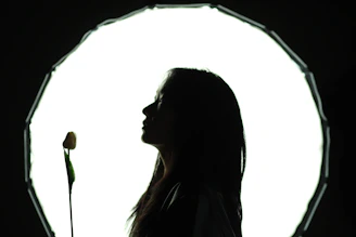 A woman standing in front of a circular light