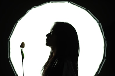 A woman standing in front of a circular light