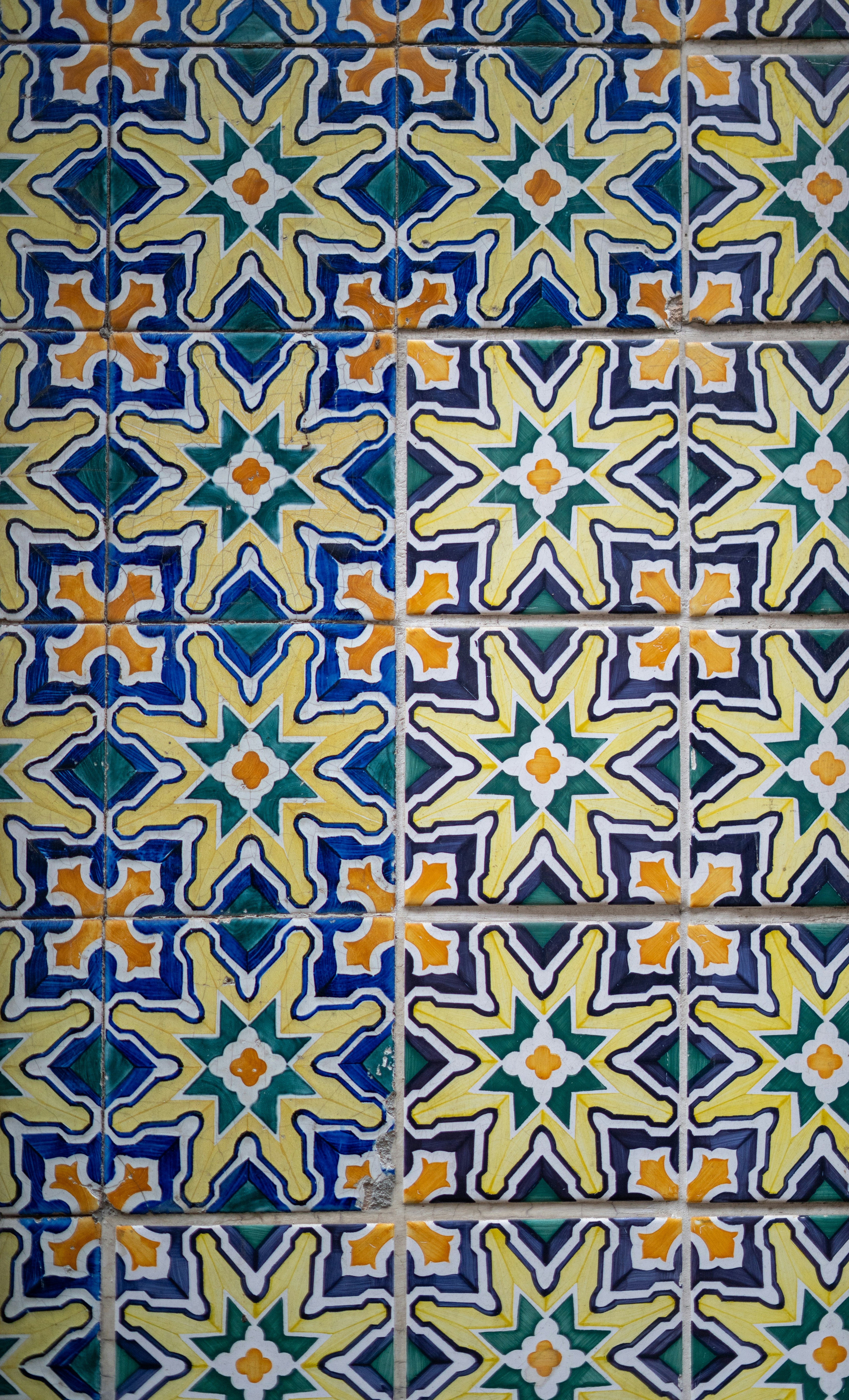 A colorful tile pattern on the wall of a building