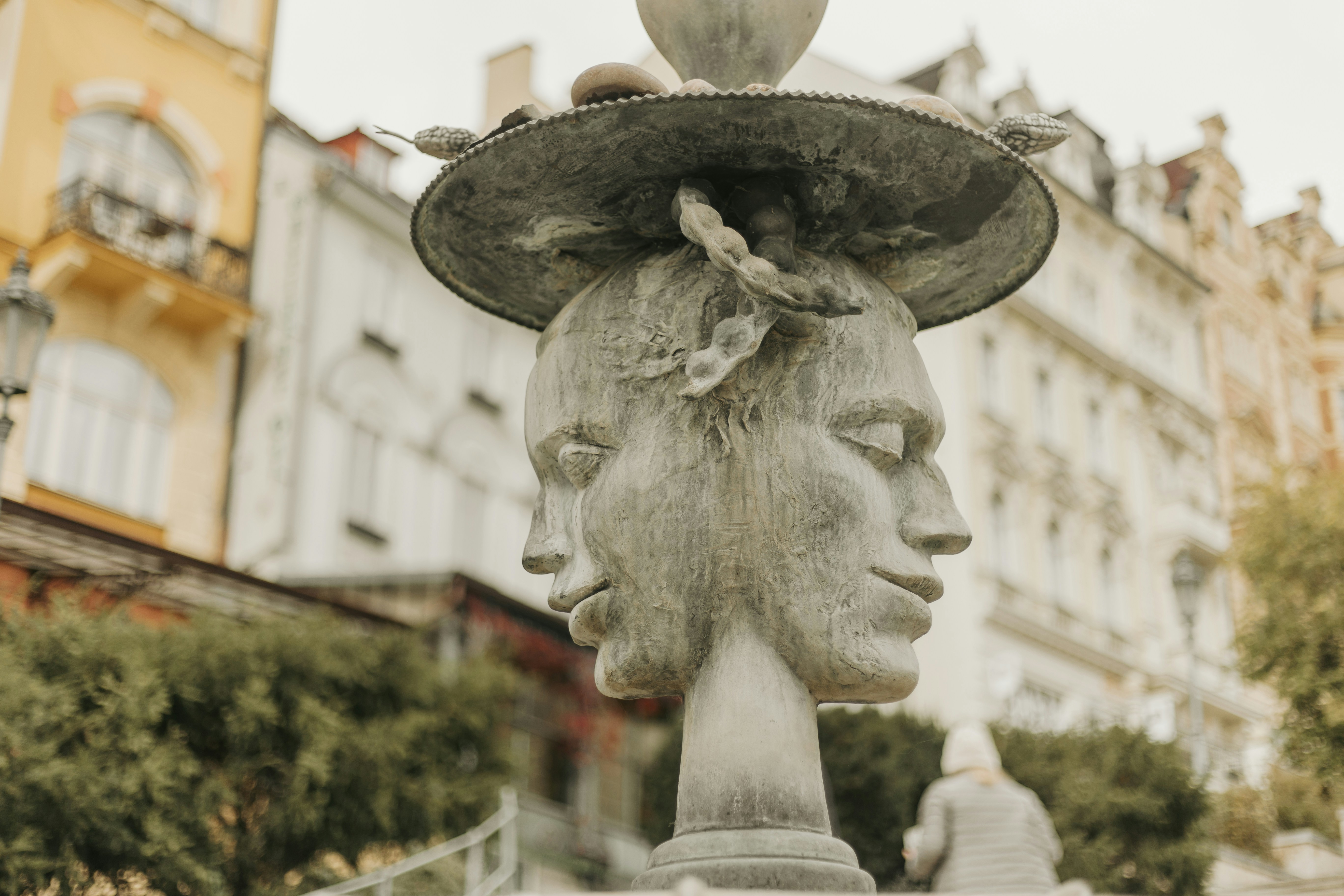 A statue of a woman with a bird on her head