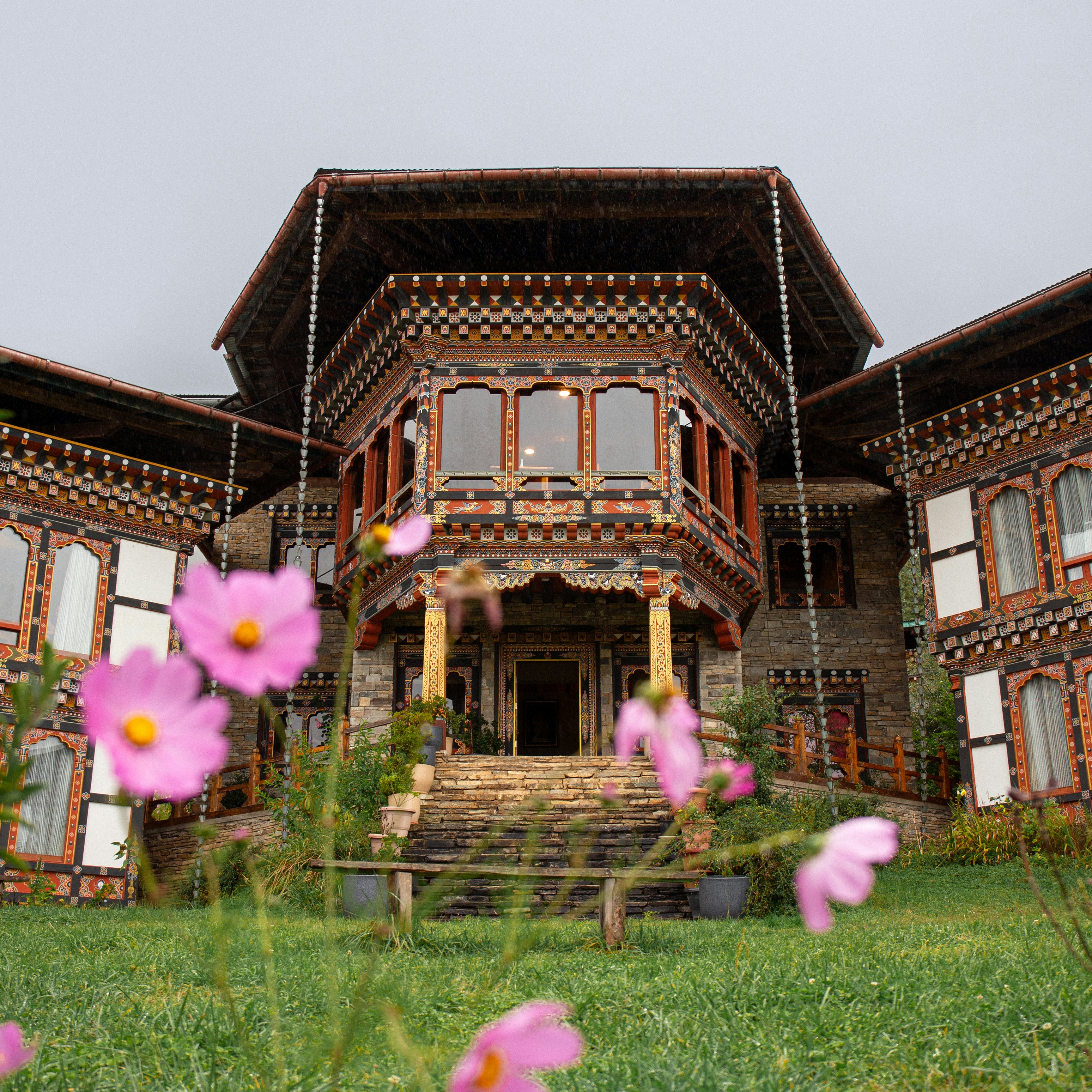 A large building with a bunch of flowers in front of it