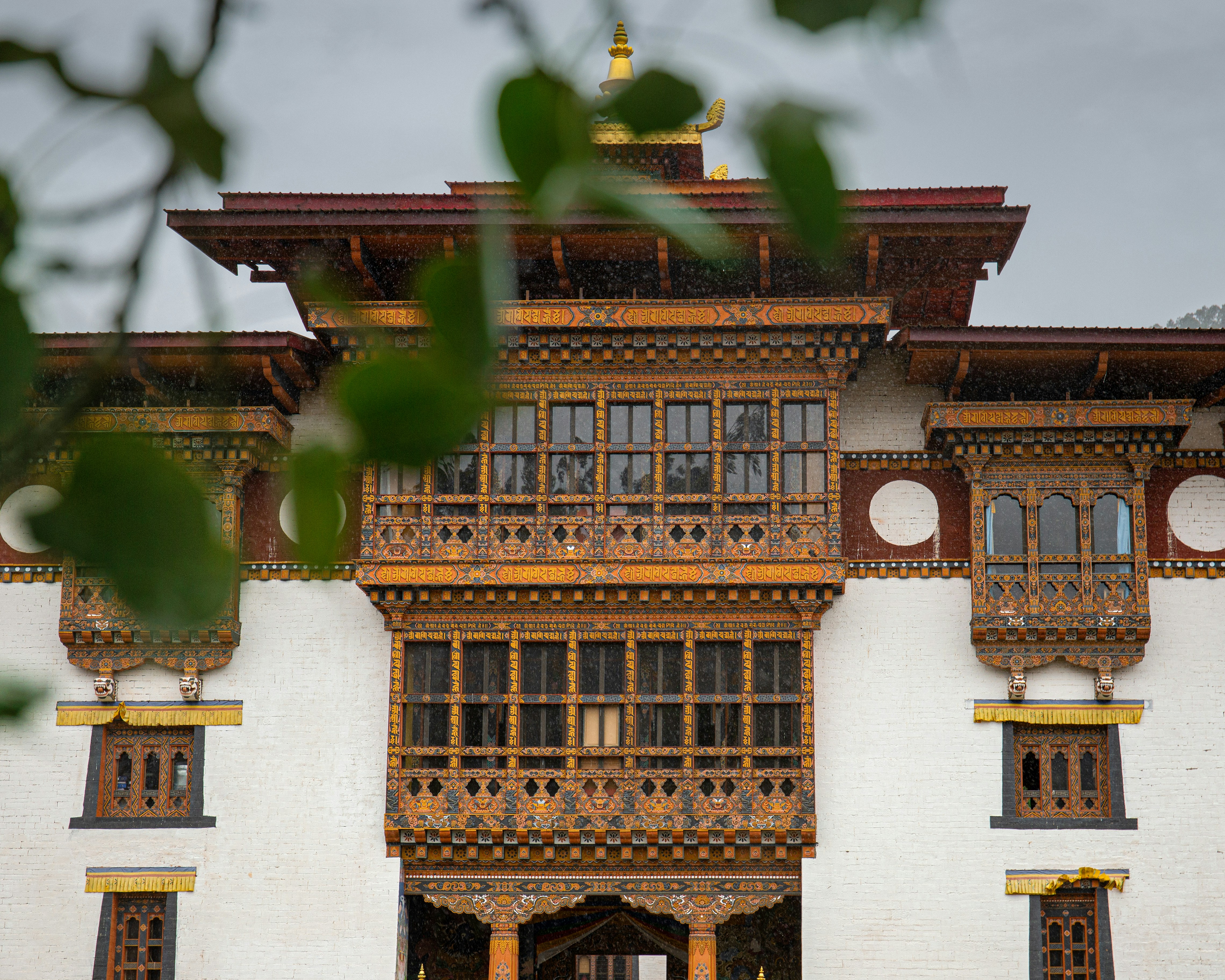 A large white building with wooden balconies, 