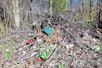 A pile of trash sitting in the middle of a forest