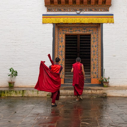A couple of people that are standing in front of a building