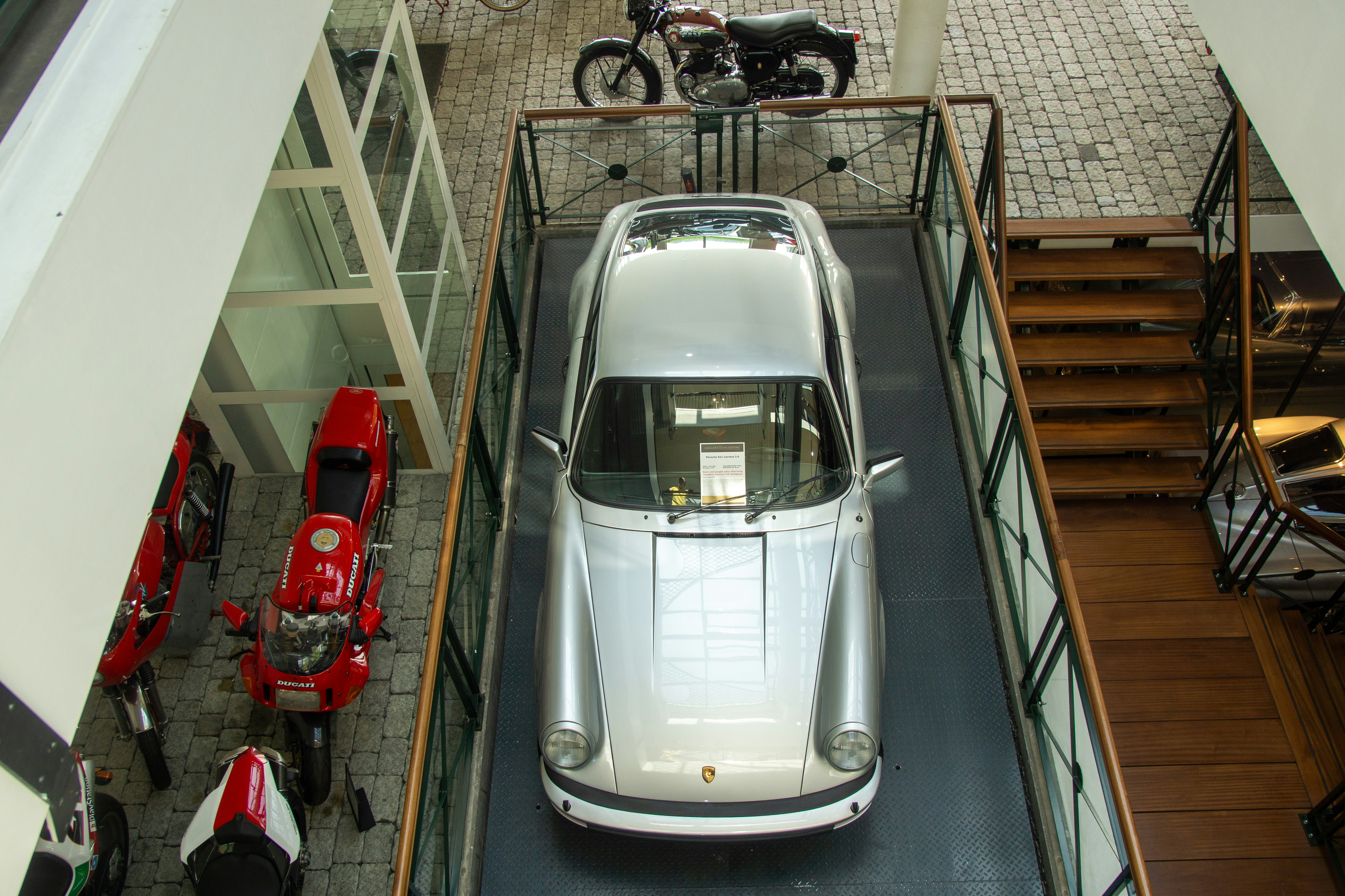 Family evaluating an electric vehicle at a dealership, considering pricing and deals
