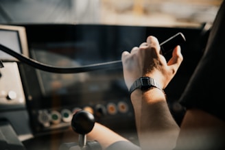A person using a cell phone in a vehicle