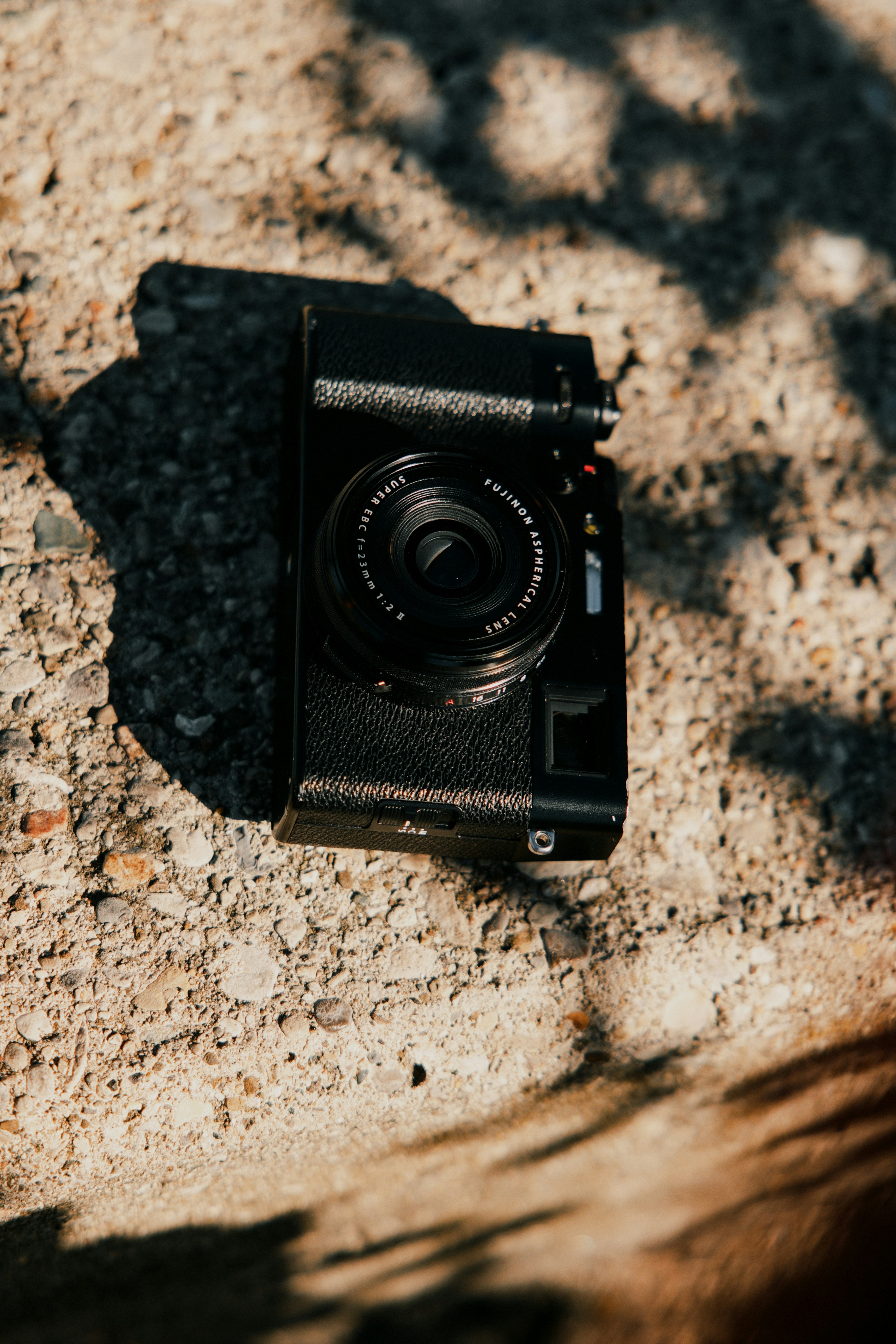 A black camera sitting on top of a rock