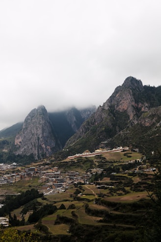 A view of a valley with mountains in the background