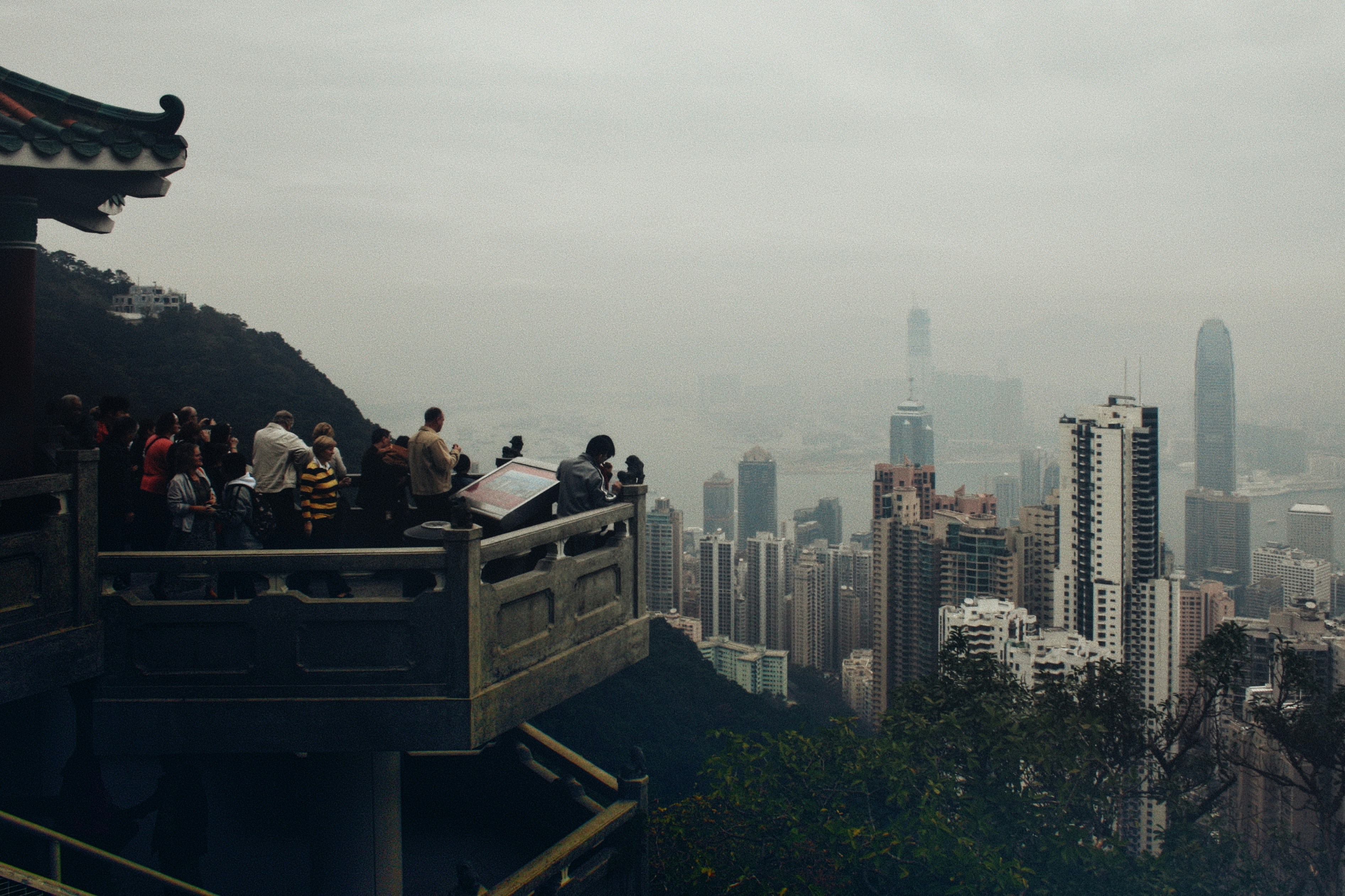 A group of people standing on top of a tall building