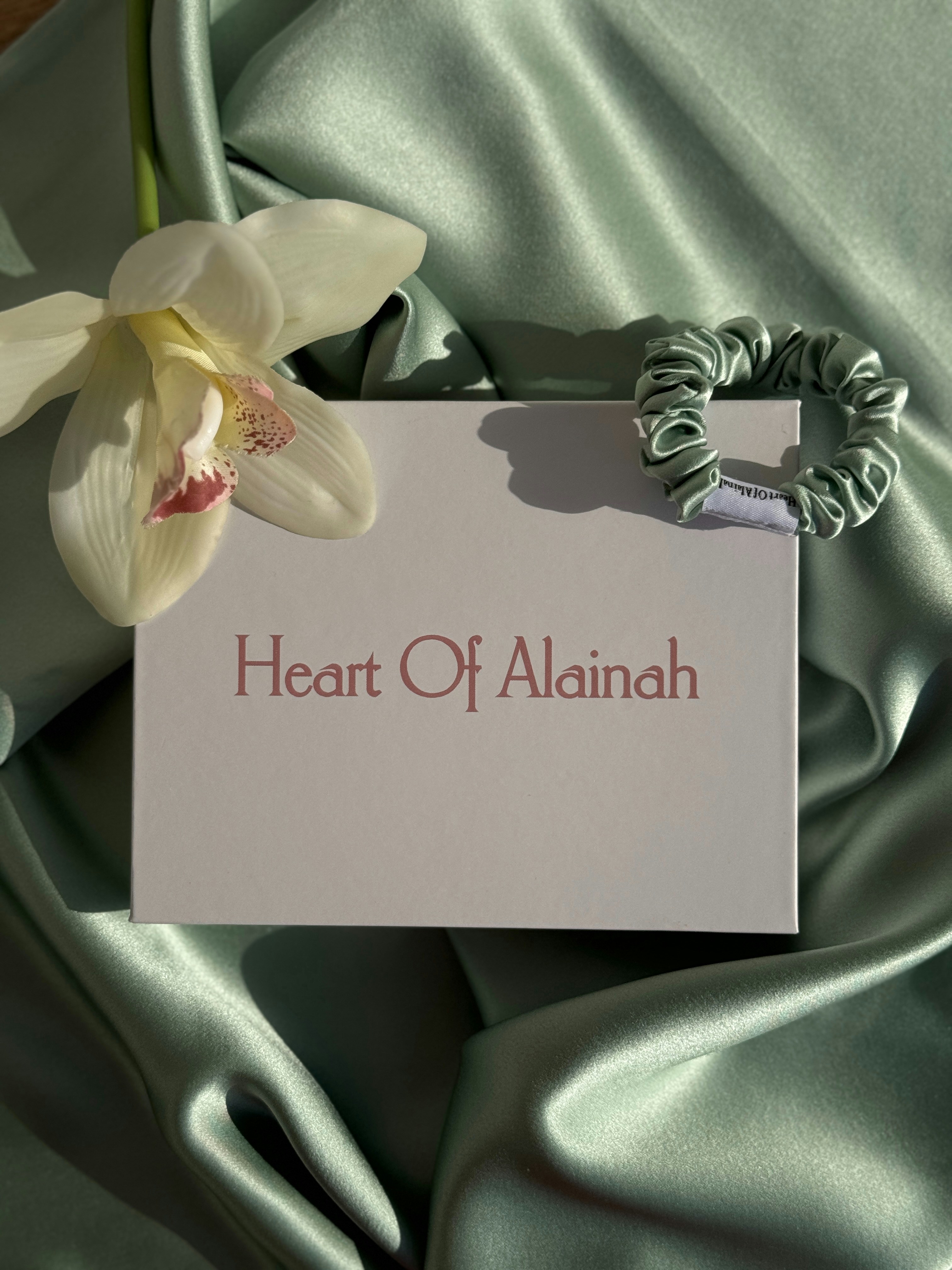 A white flower sitting on top of a green cloth