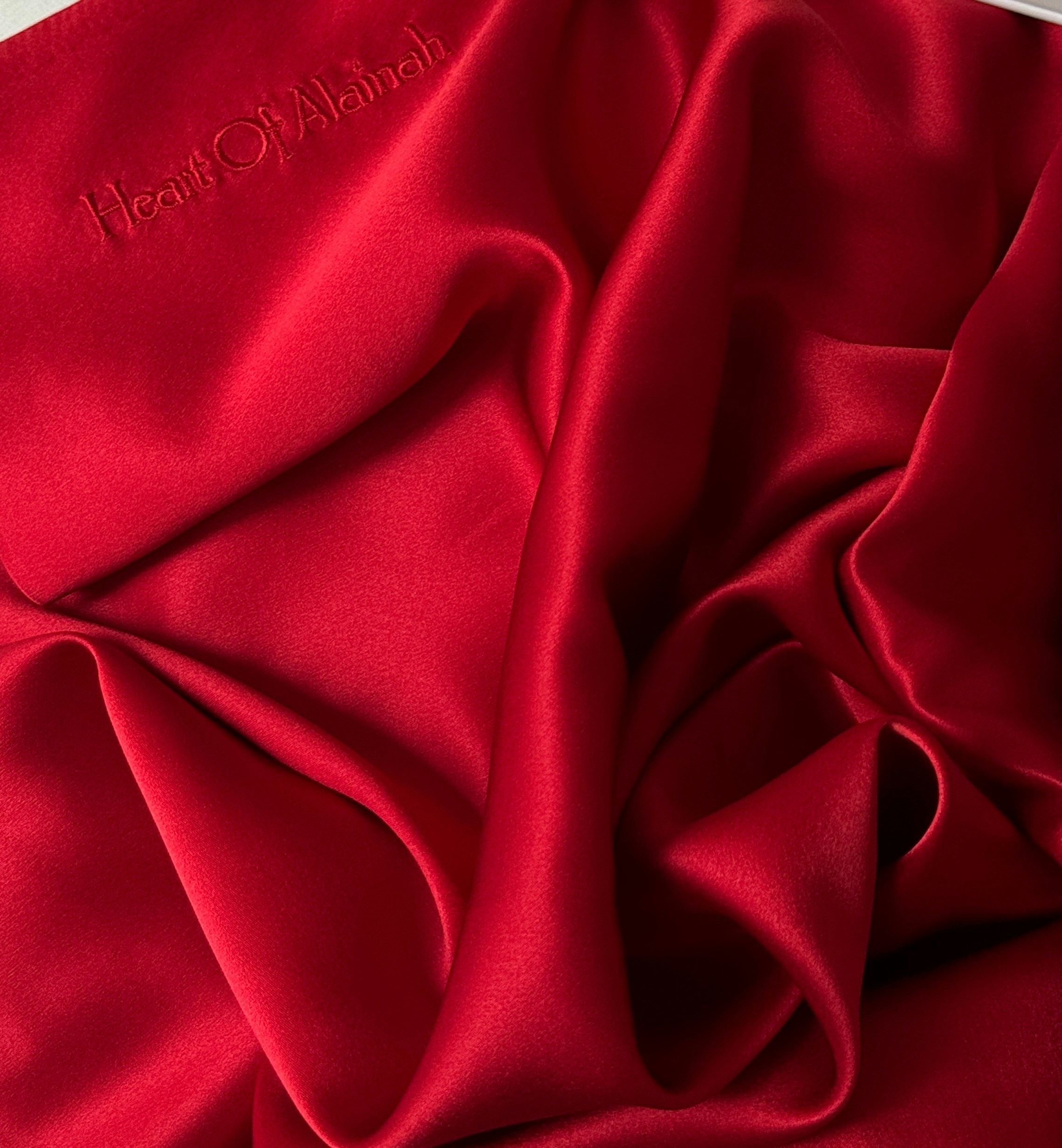 A close up of a red cloth on a white surface