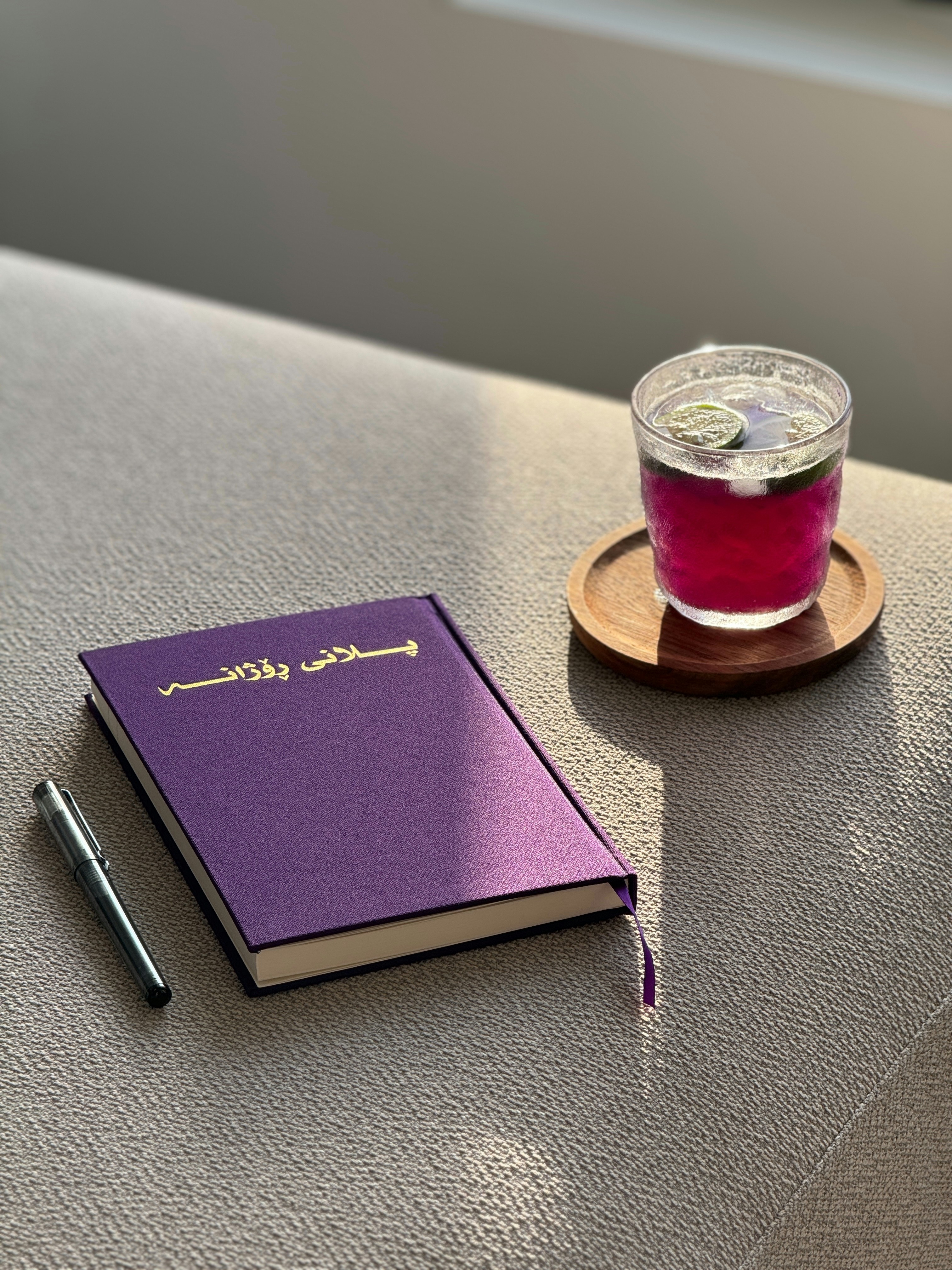 A cup of tea and a book on a table