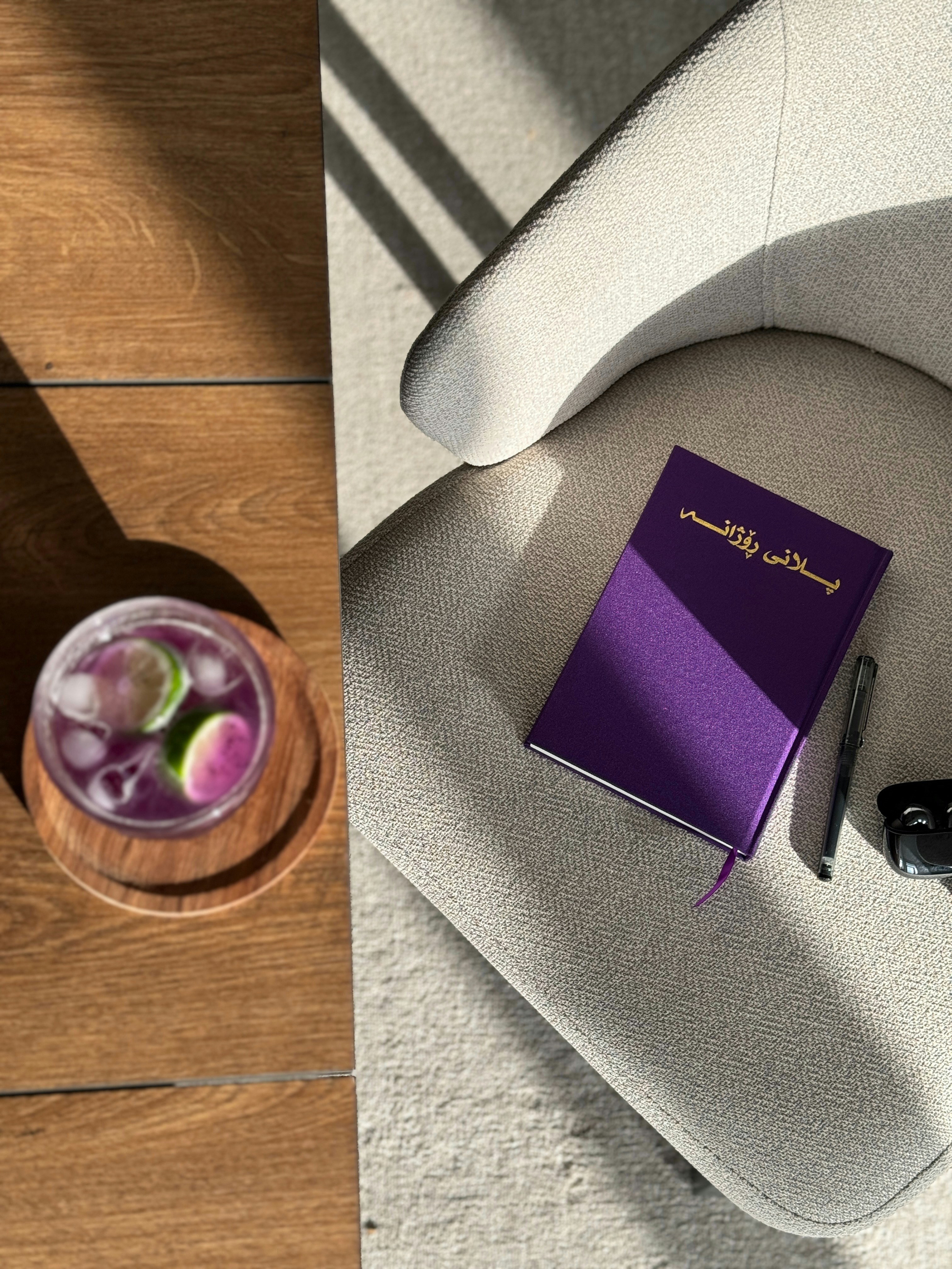 A purple book sitting on top of a white chair