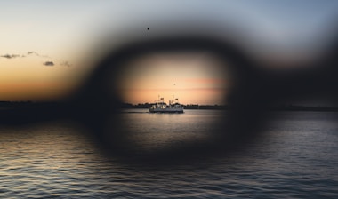 A view of a boat in the water through a magnifying glass