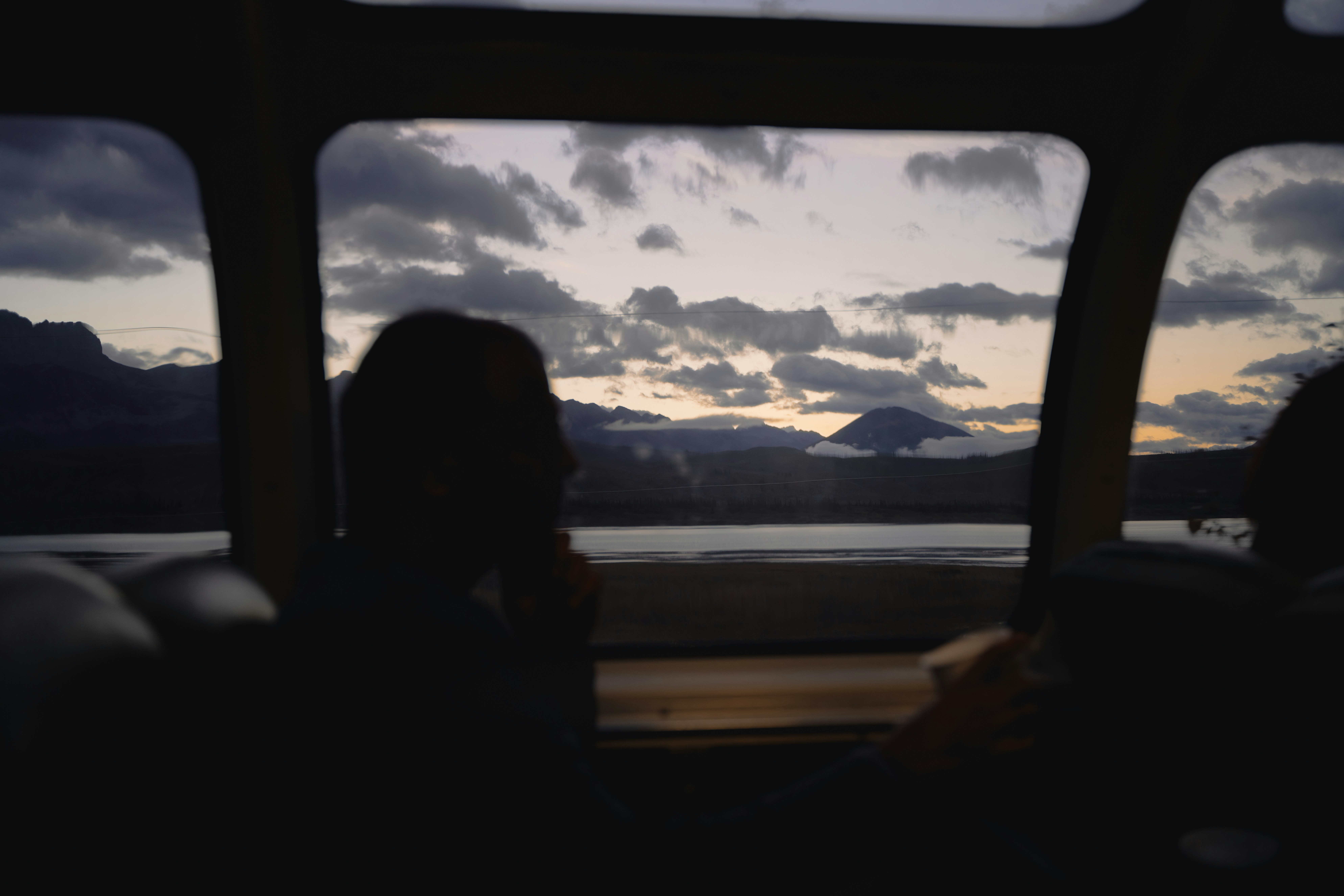 A person sitting in a bus looking out the window