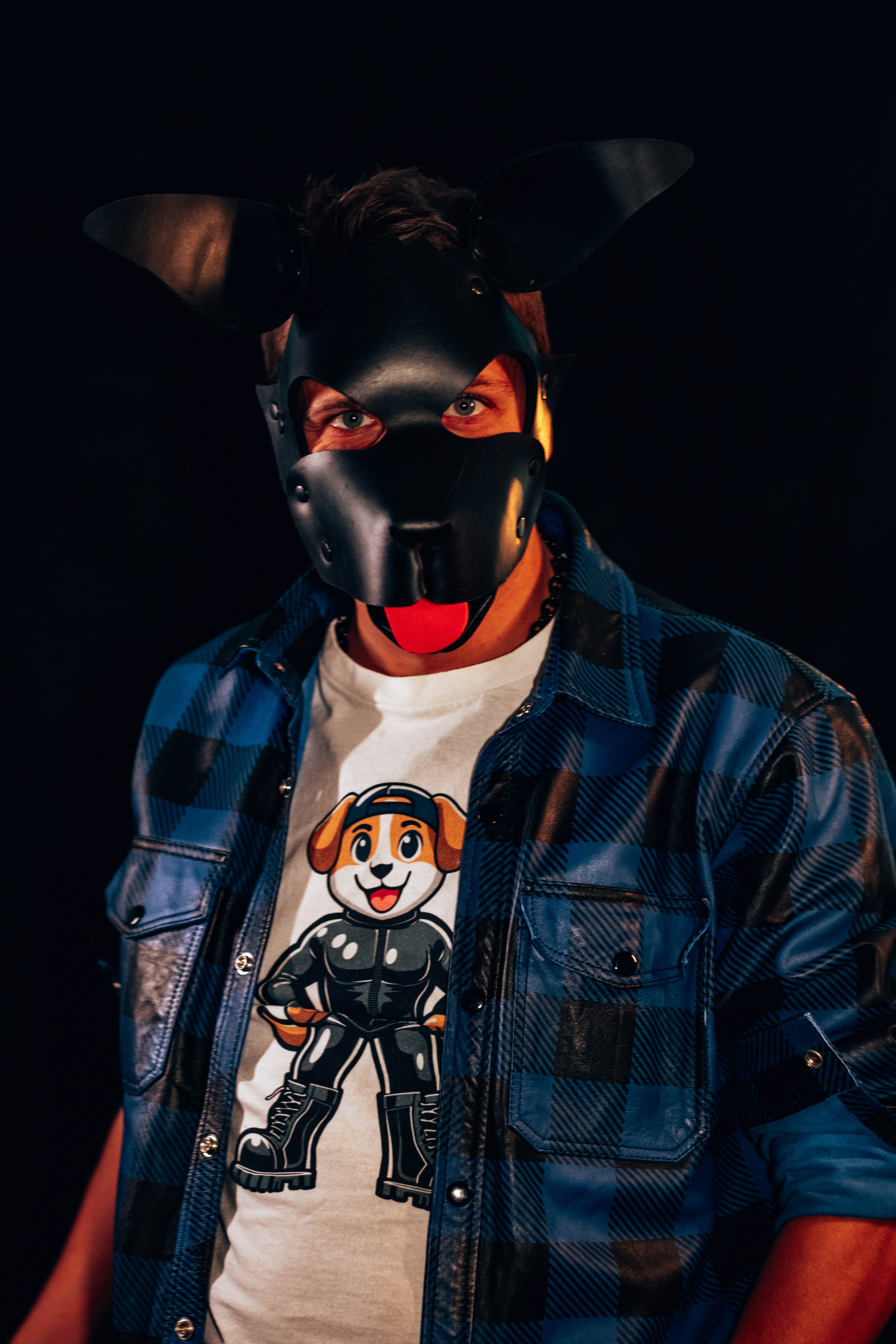 A man wearing a dog mask and jacket