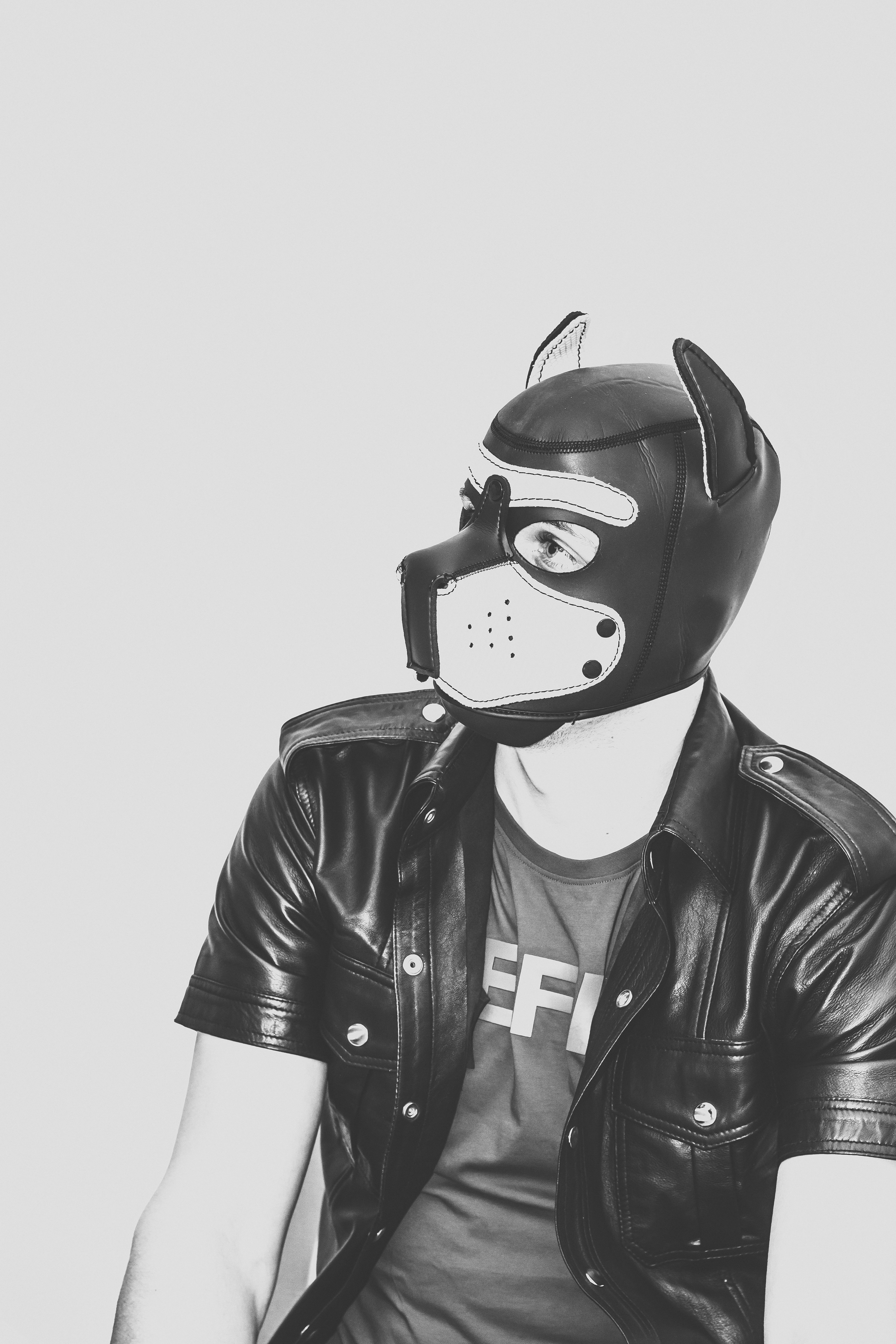 A man in a leather jacket wearing a dog mask