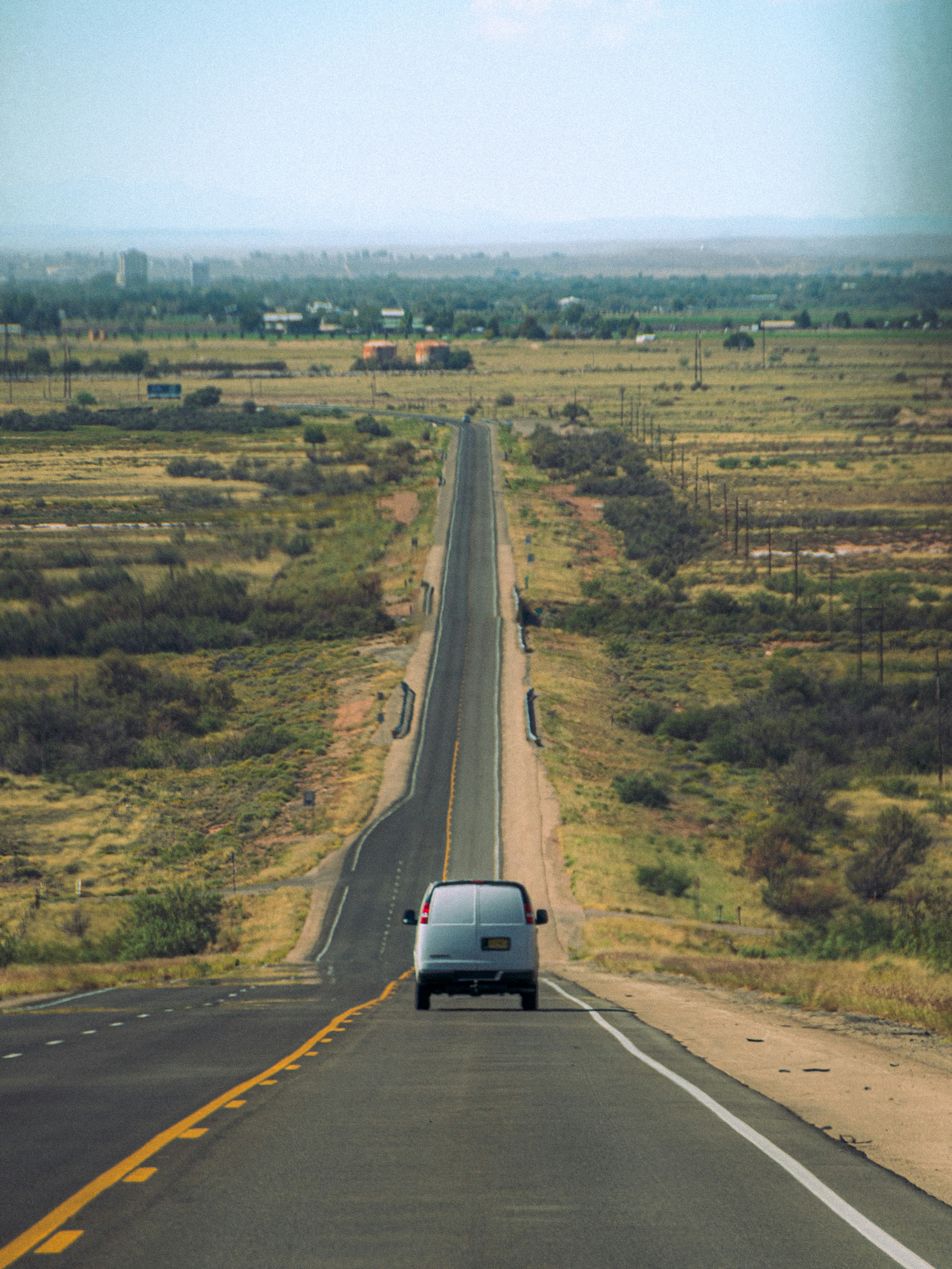 A car driving down a highway in the middle of the desert