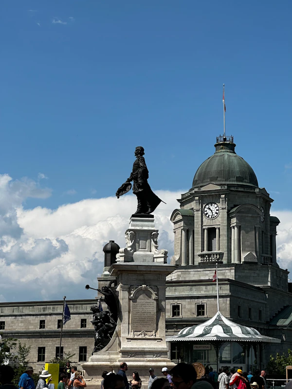 A bronze statue in front of a domed stone building