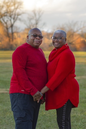 A couple of people that are standing in the grass