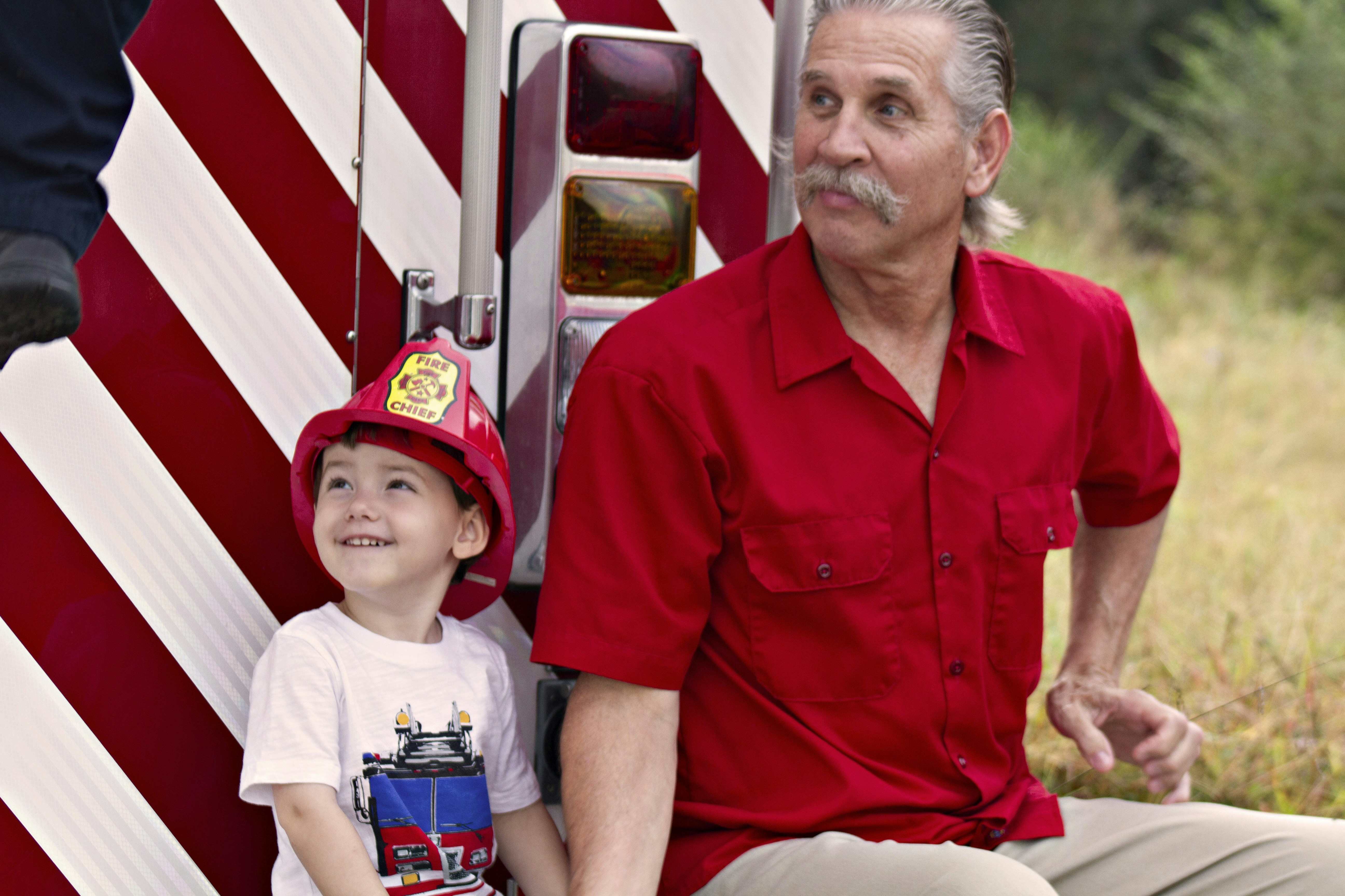 firefighter helping a child - Behind the Badge: Real Stories of American Heroes in Pop Culture