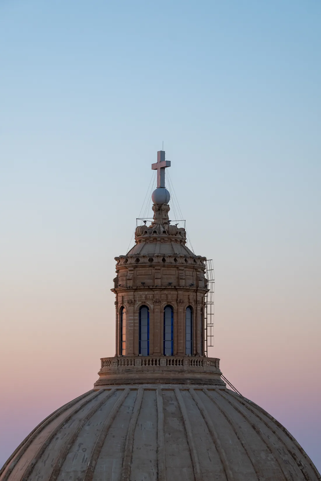 Sunset behind a cathedral dome in Valletta, Malta