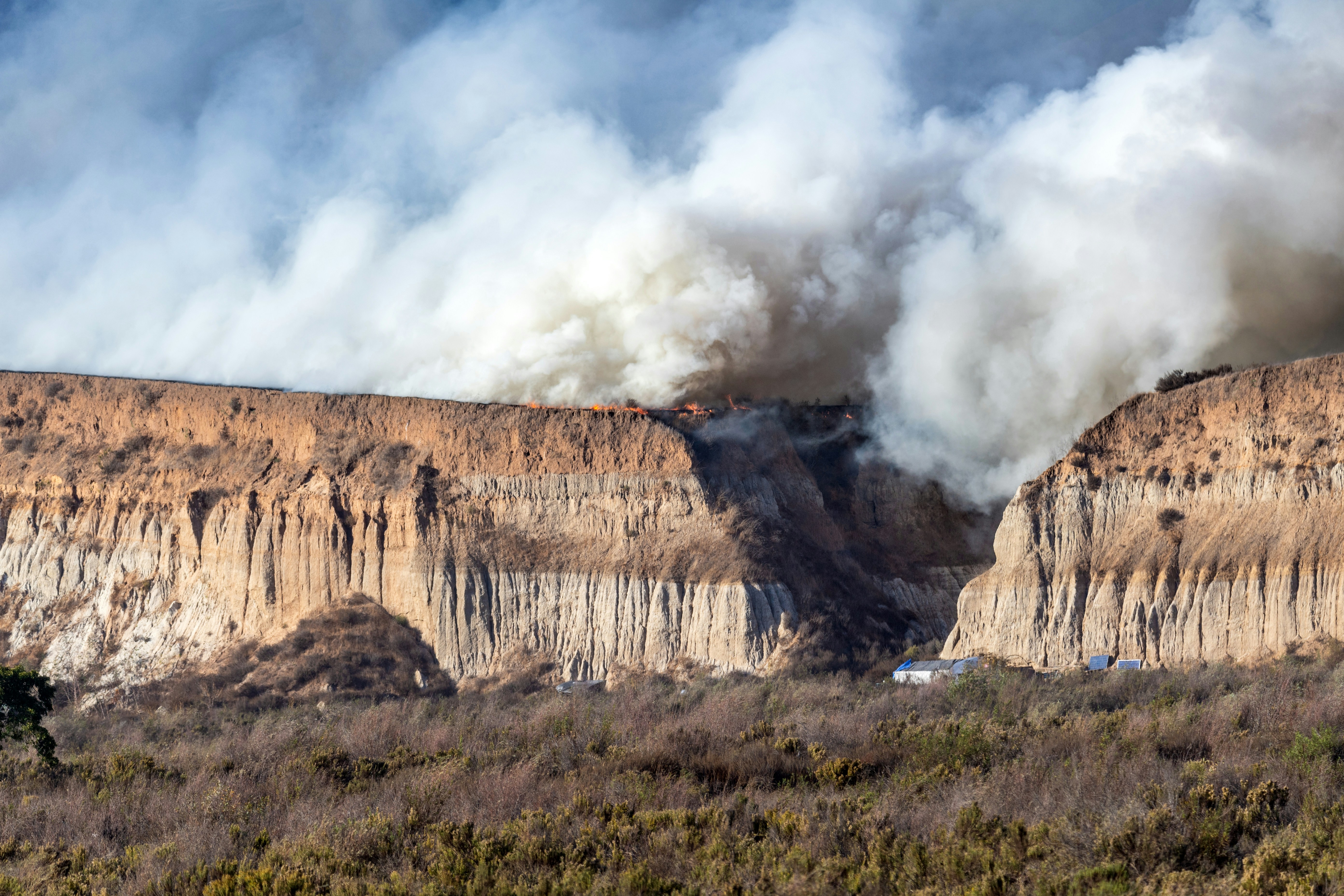 A large plume of smoke billowing out of a mountain