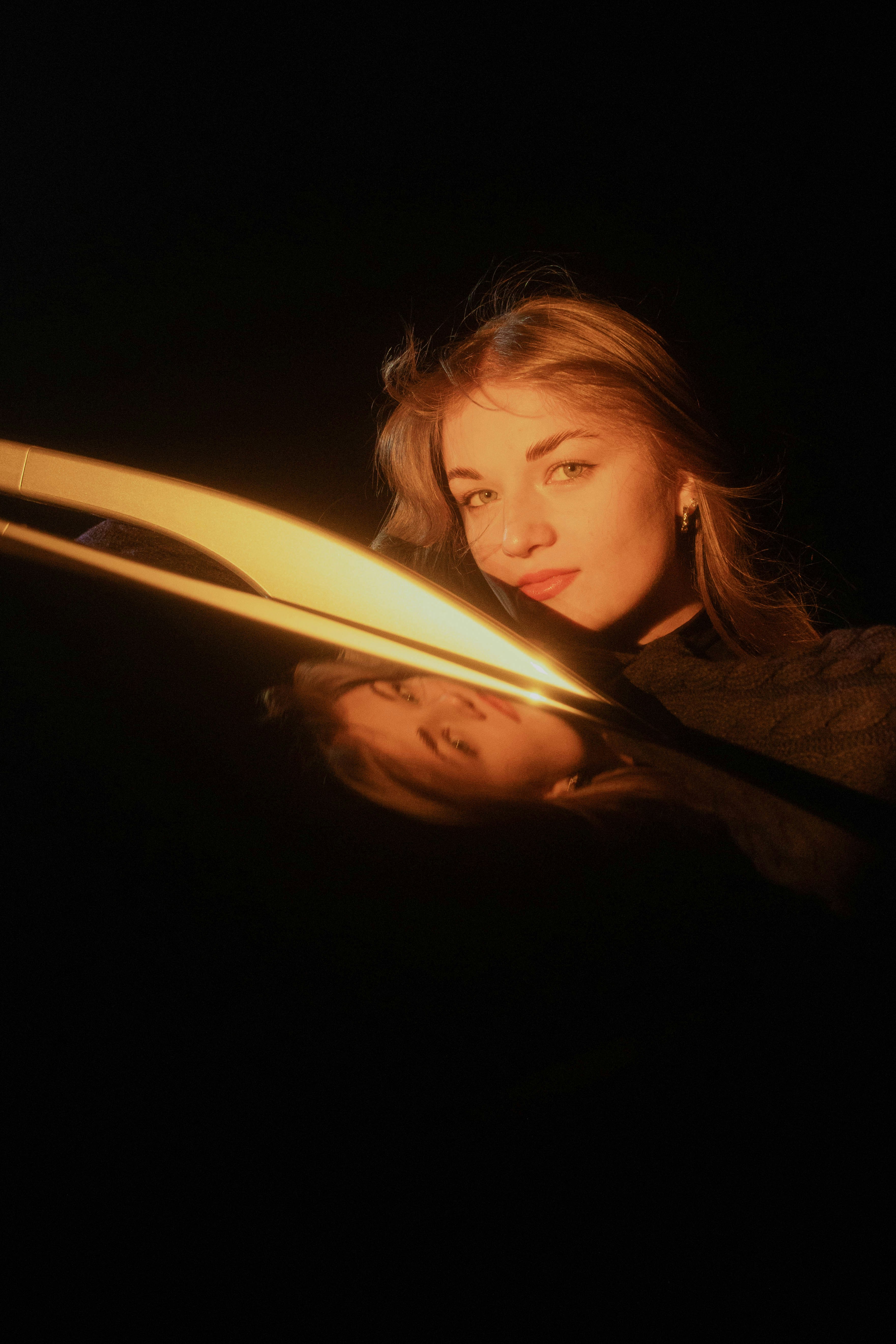 A woman holding a lit object in the dark photo – Free Portrait Image on ...