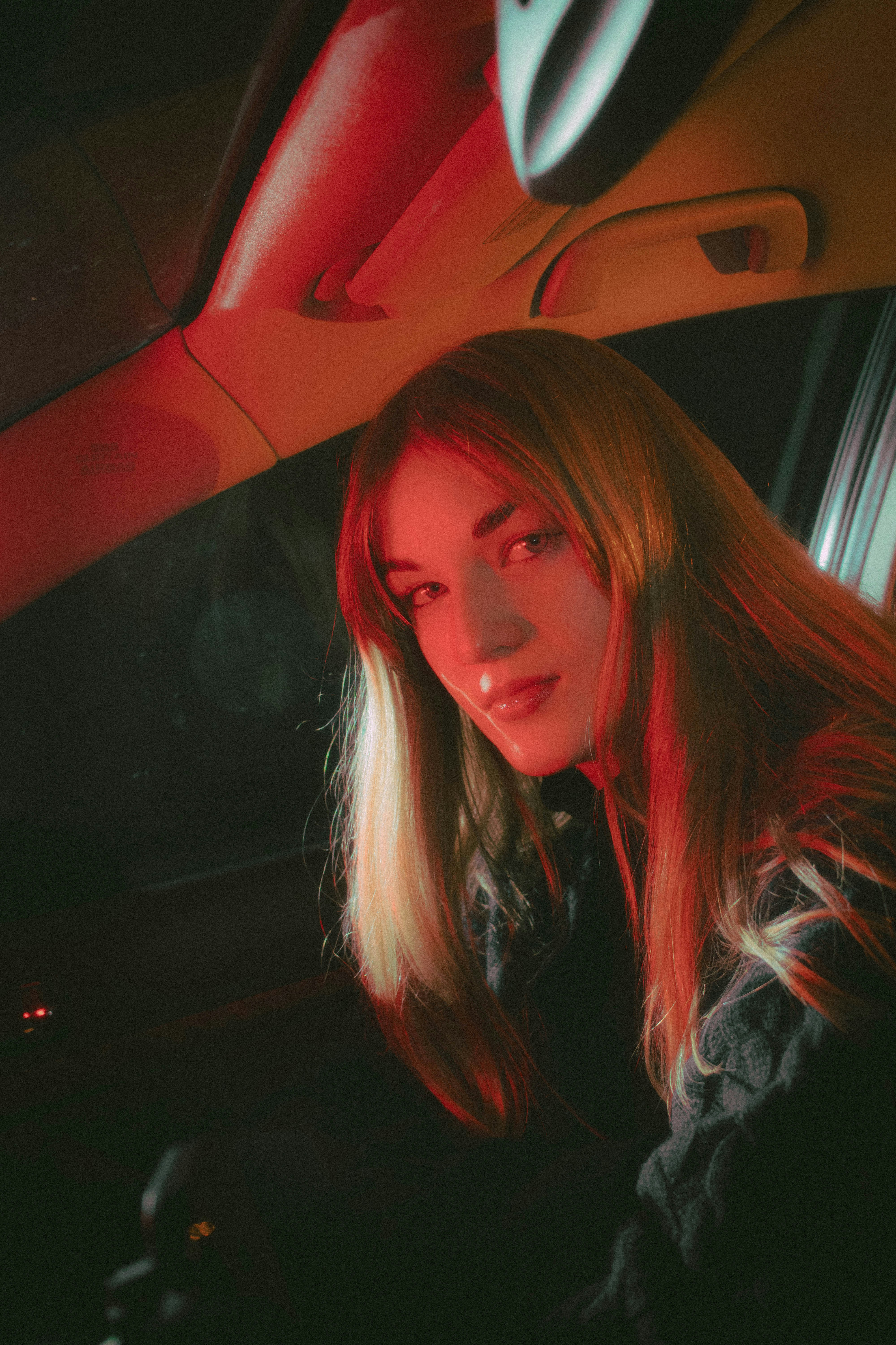 A woman sitting in the passenger seat of a car