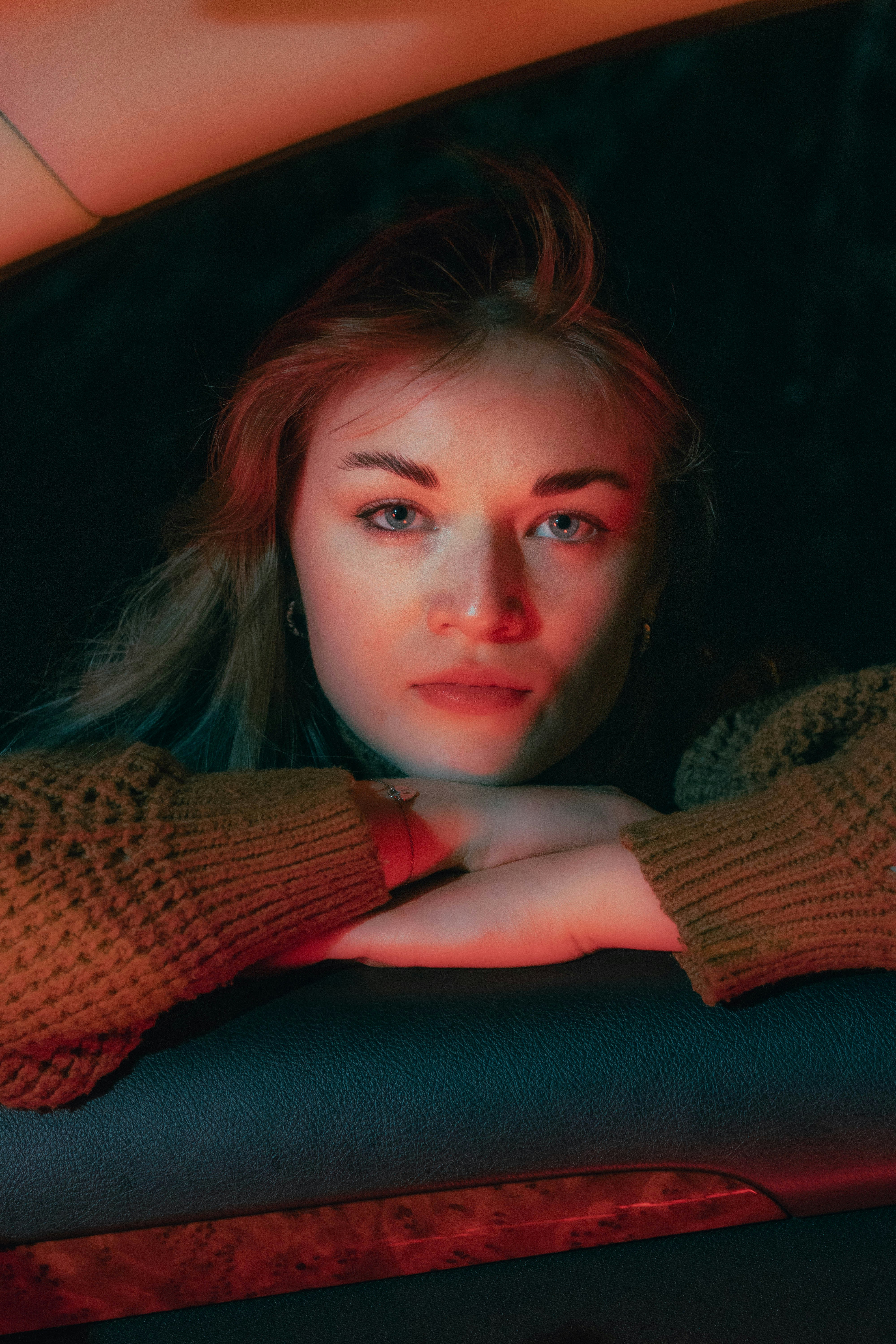 A woman sitting in the back seat of a car