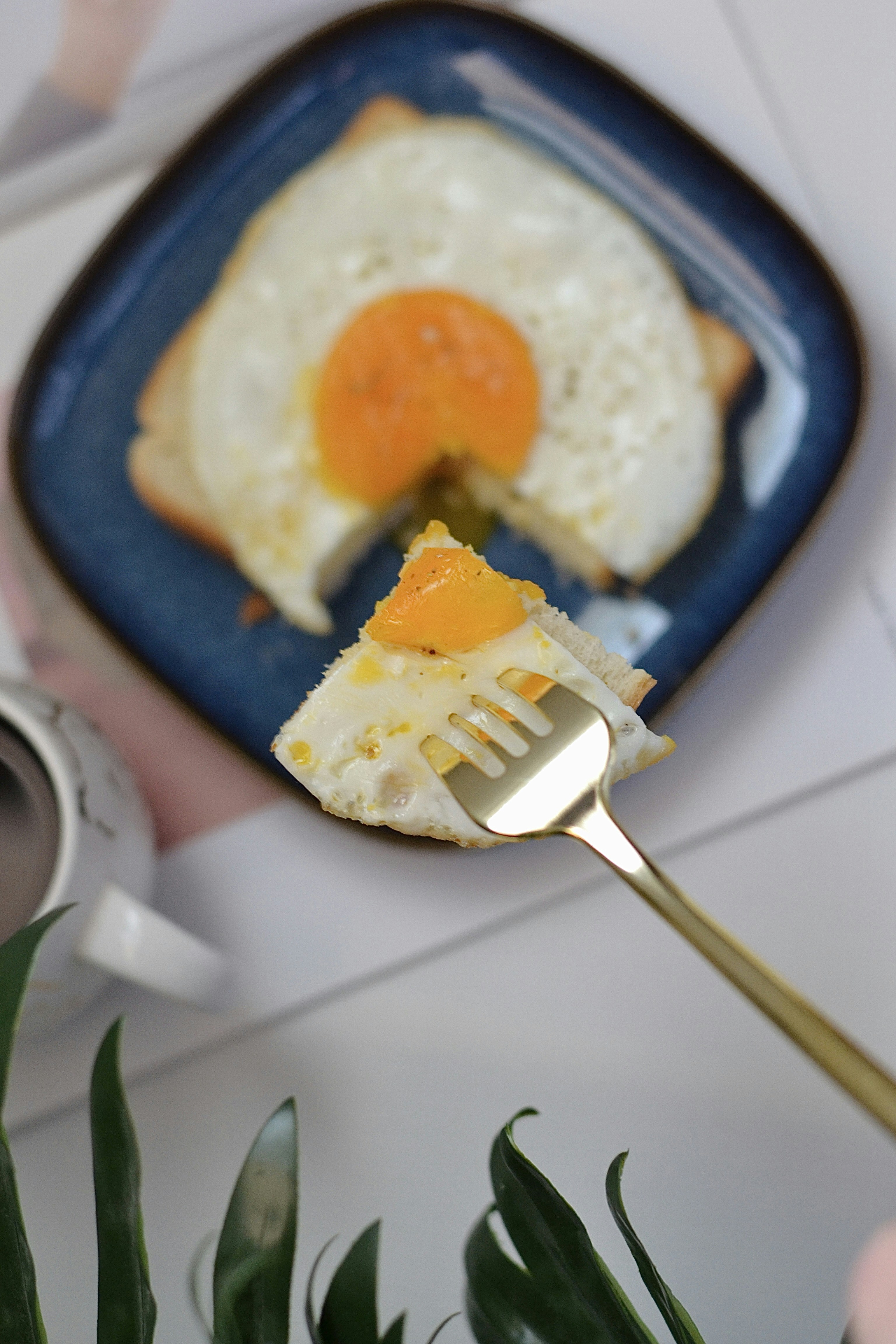 A person holding a fork with a piece of food on it