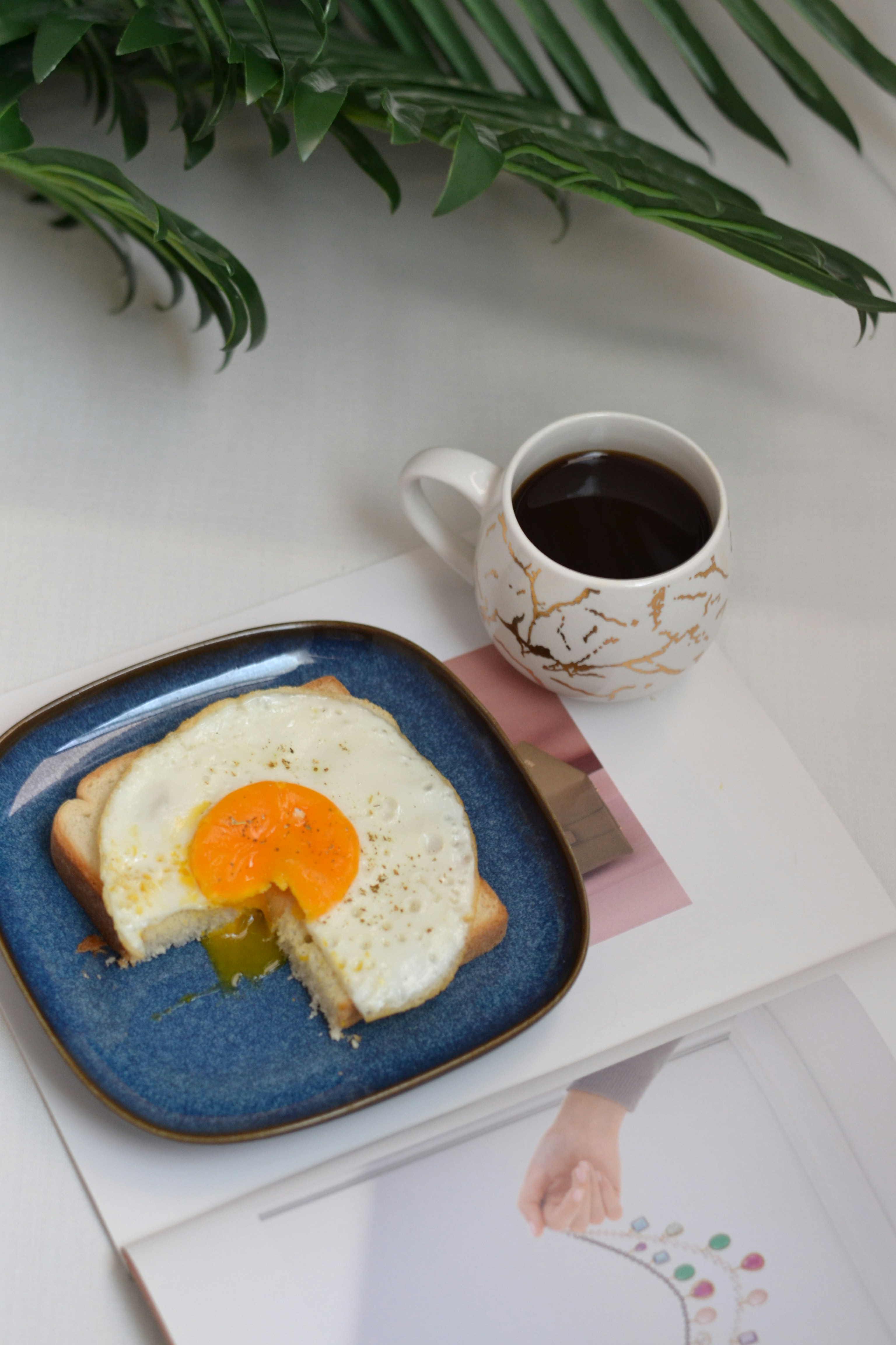 A plate with a piece of toast and an egg on it