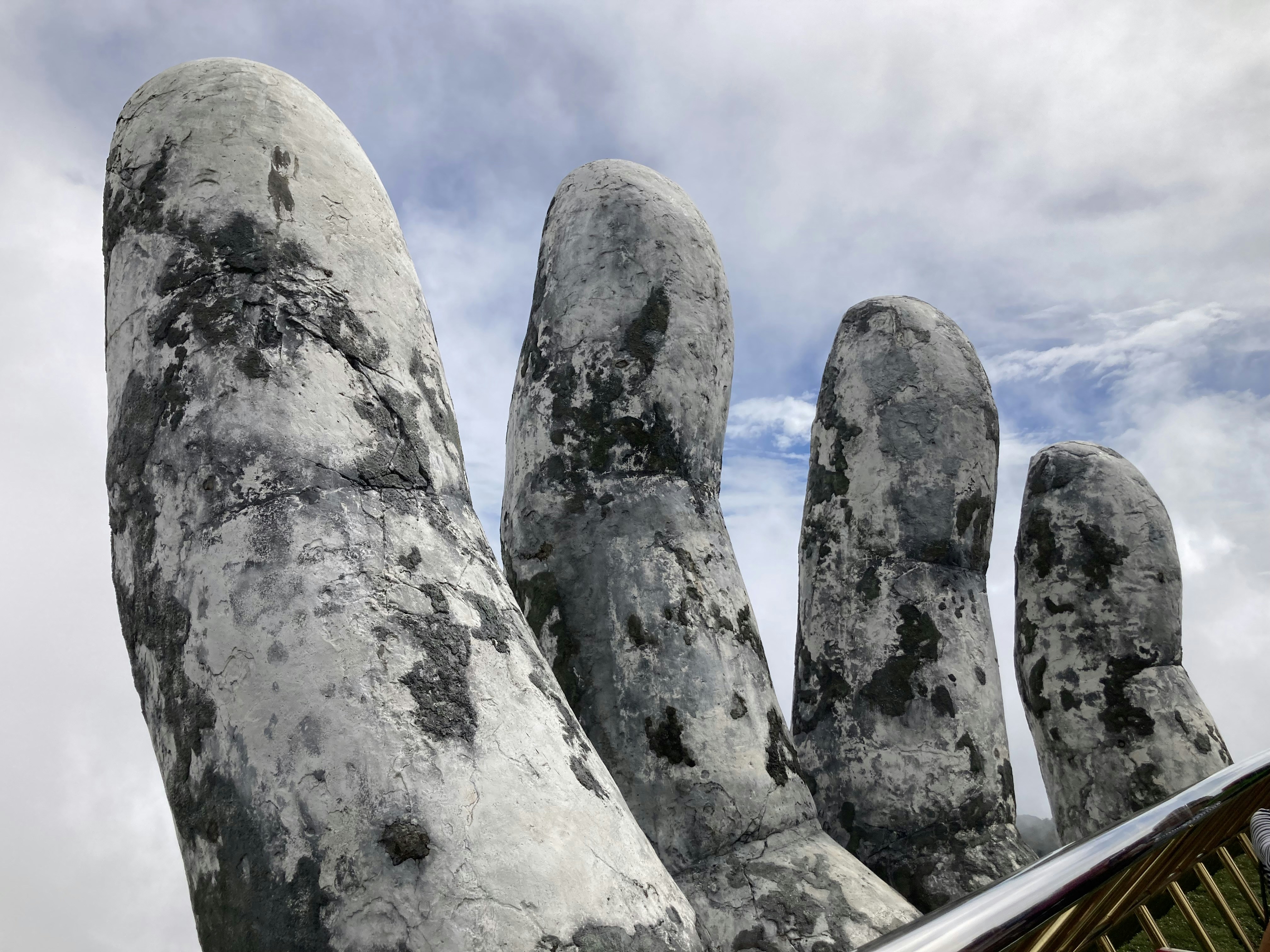 A large statue of a hand reaching up into the sky