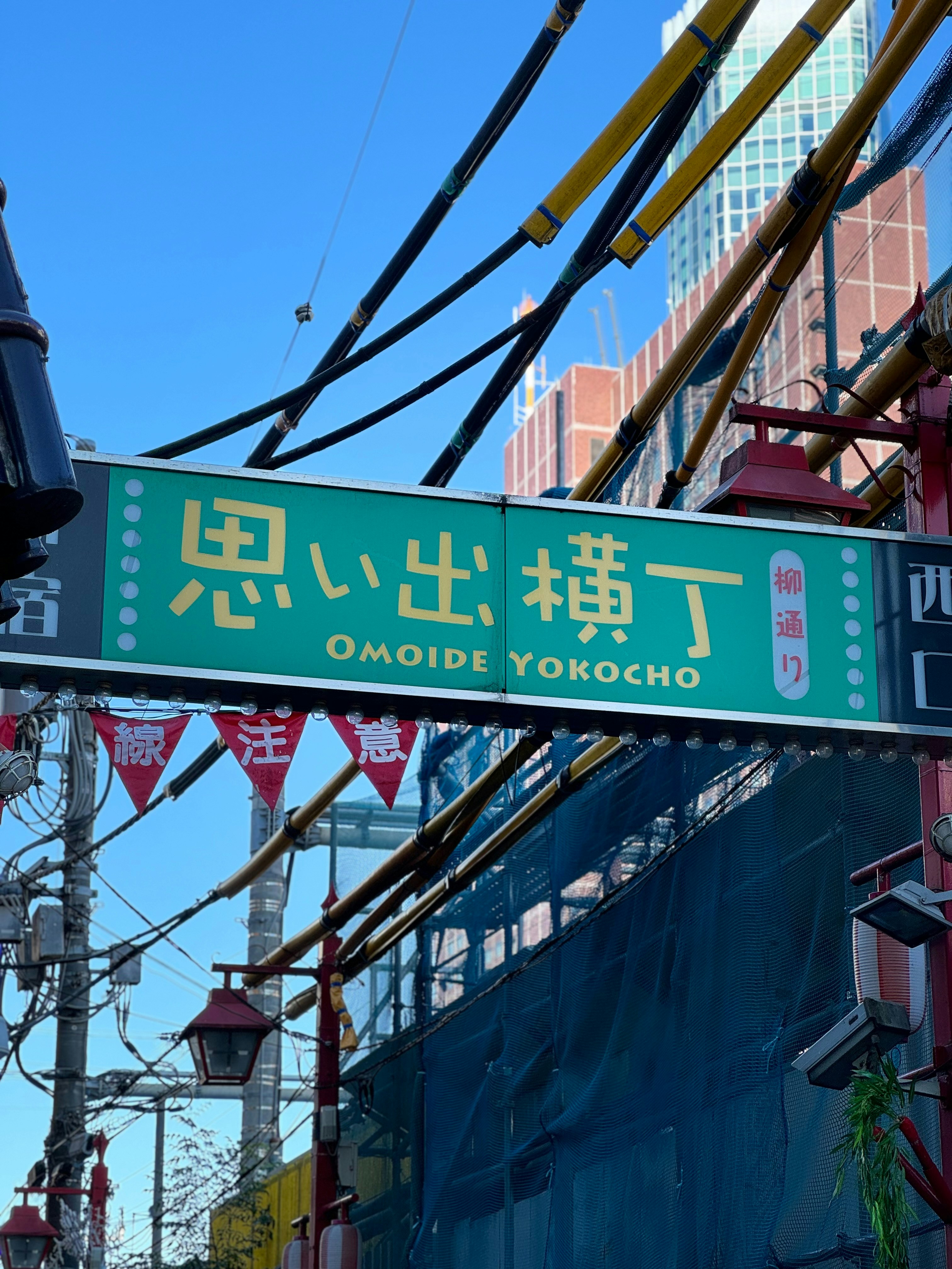 A green street sign hanging from the side of a building