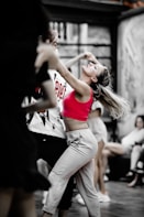 A woman in a red top is dancing