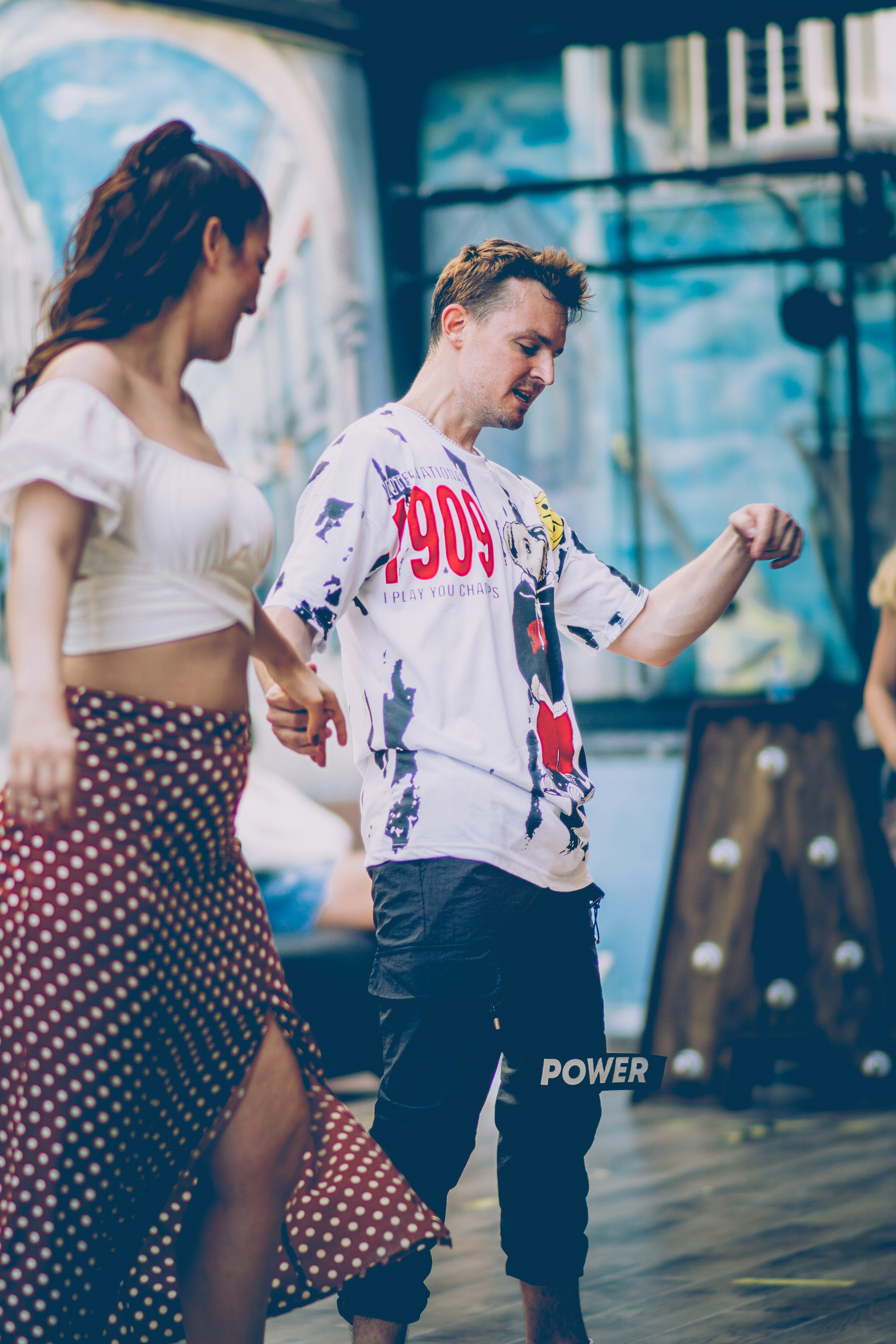A man and a woman dancing on a stage