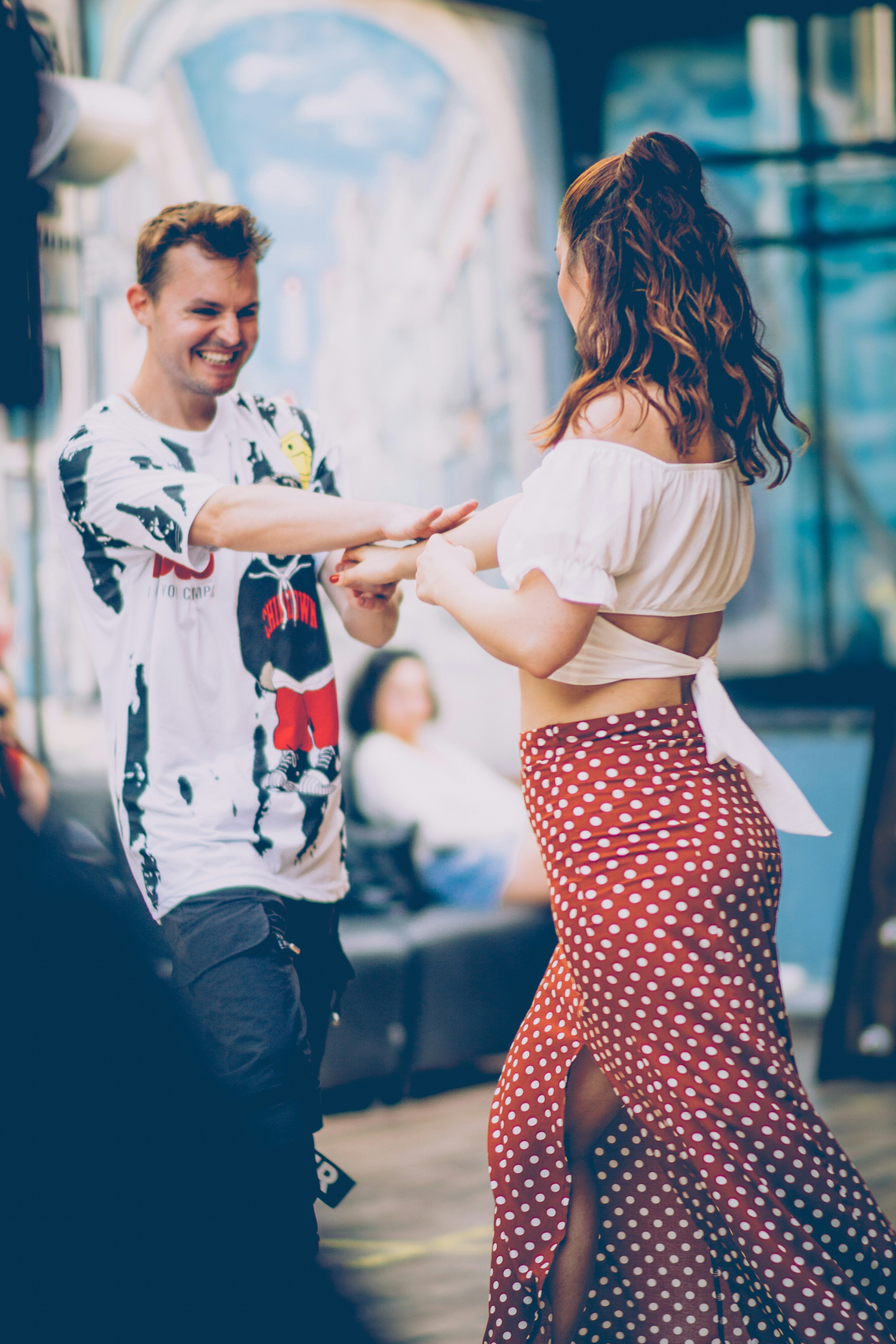 A man and a woman dancing on a stage