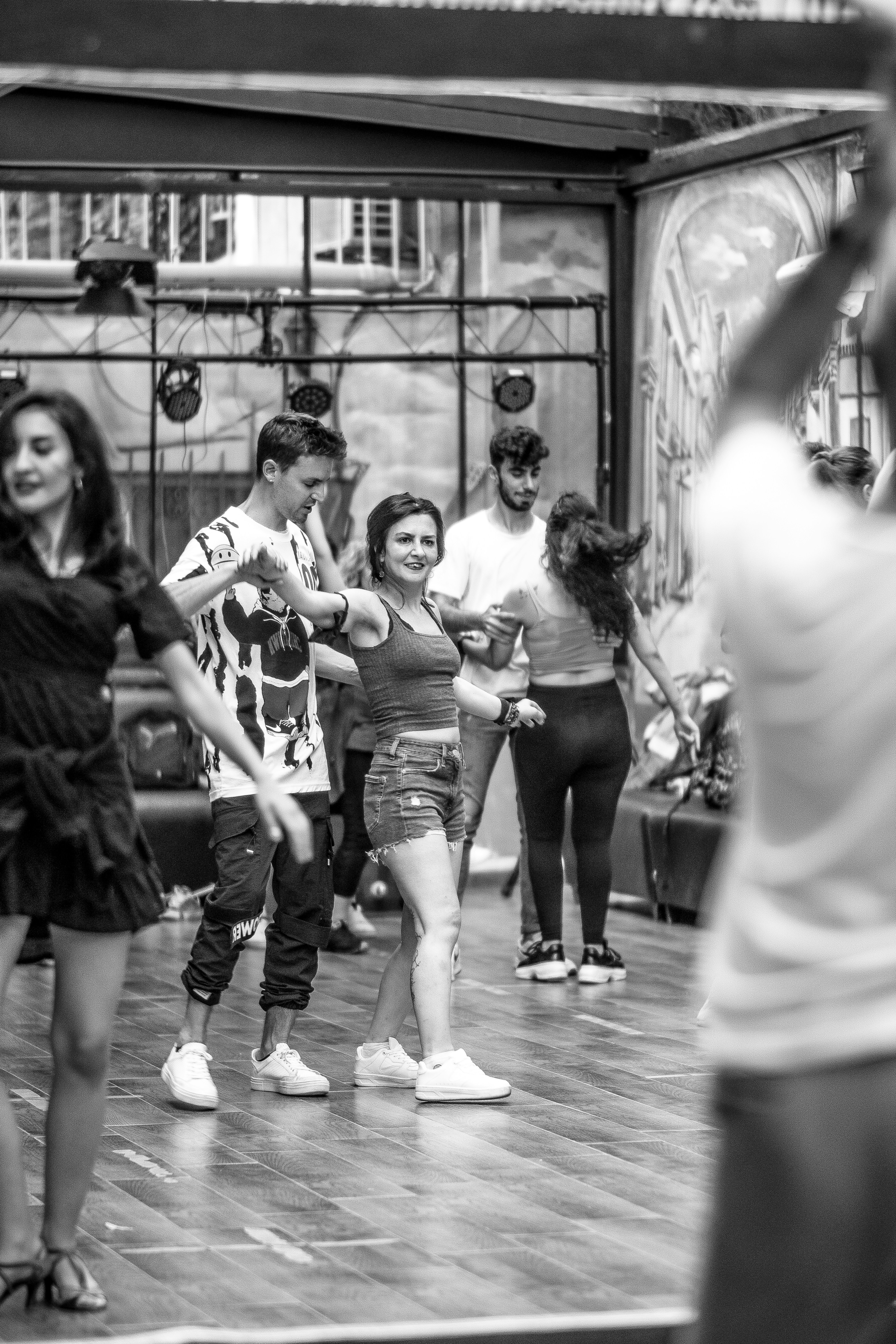 A group of people standing on top of a wooden floor