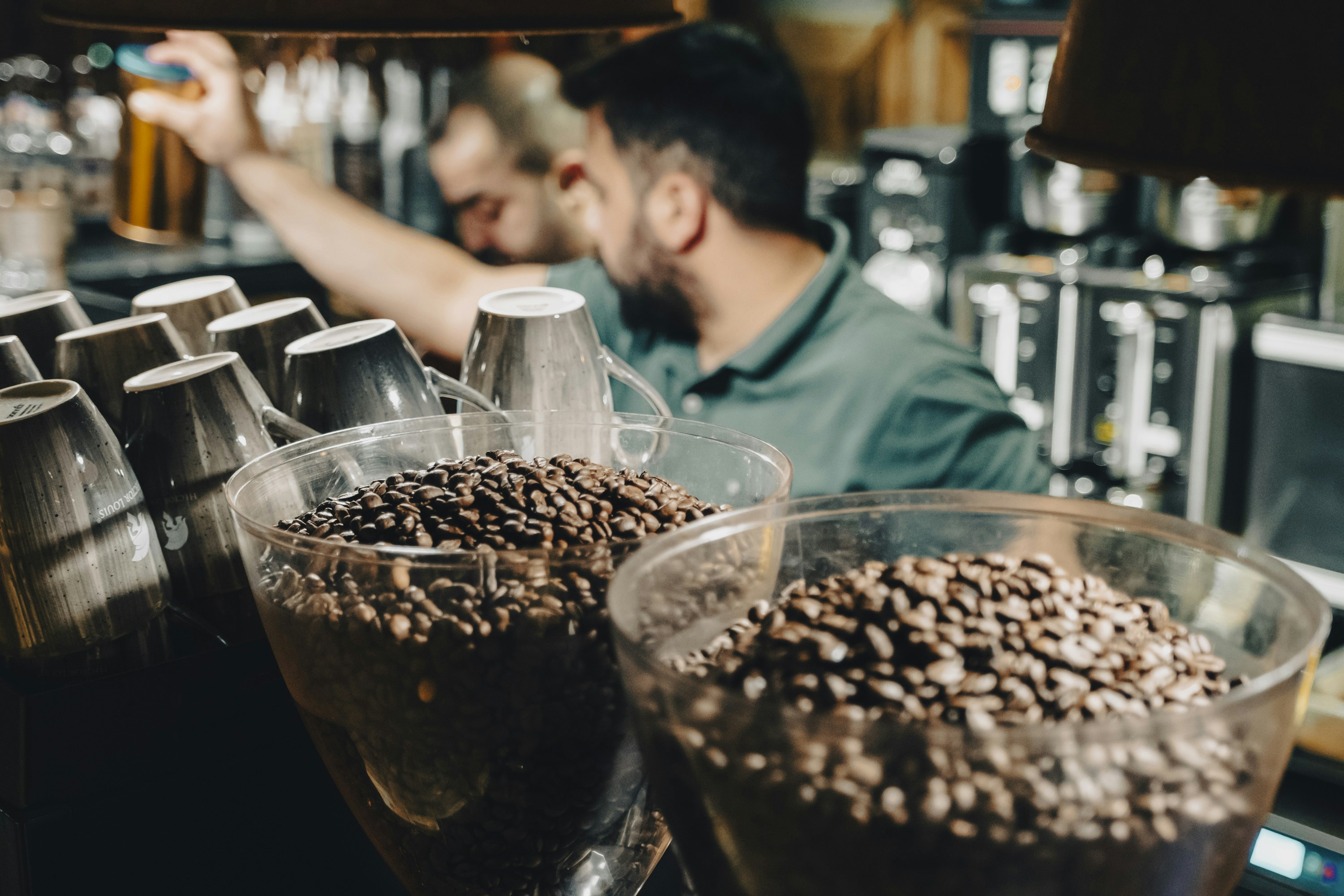 A man behind a bar making a drink