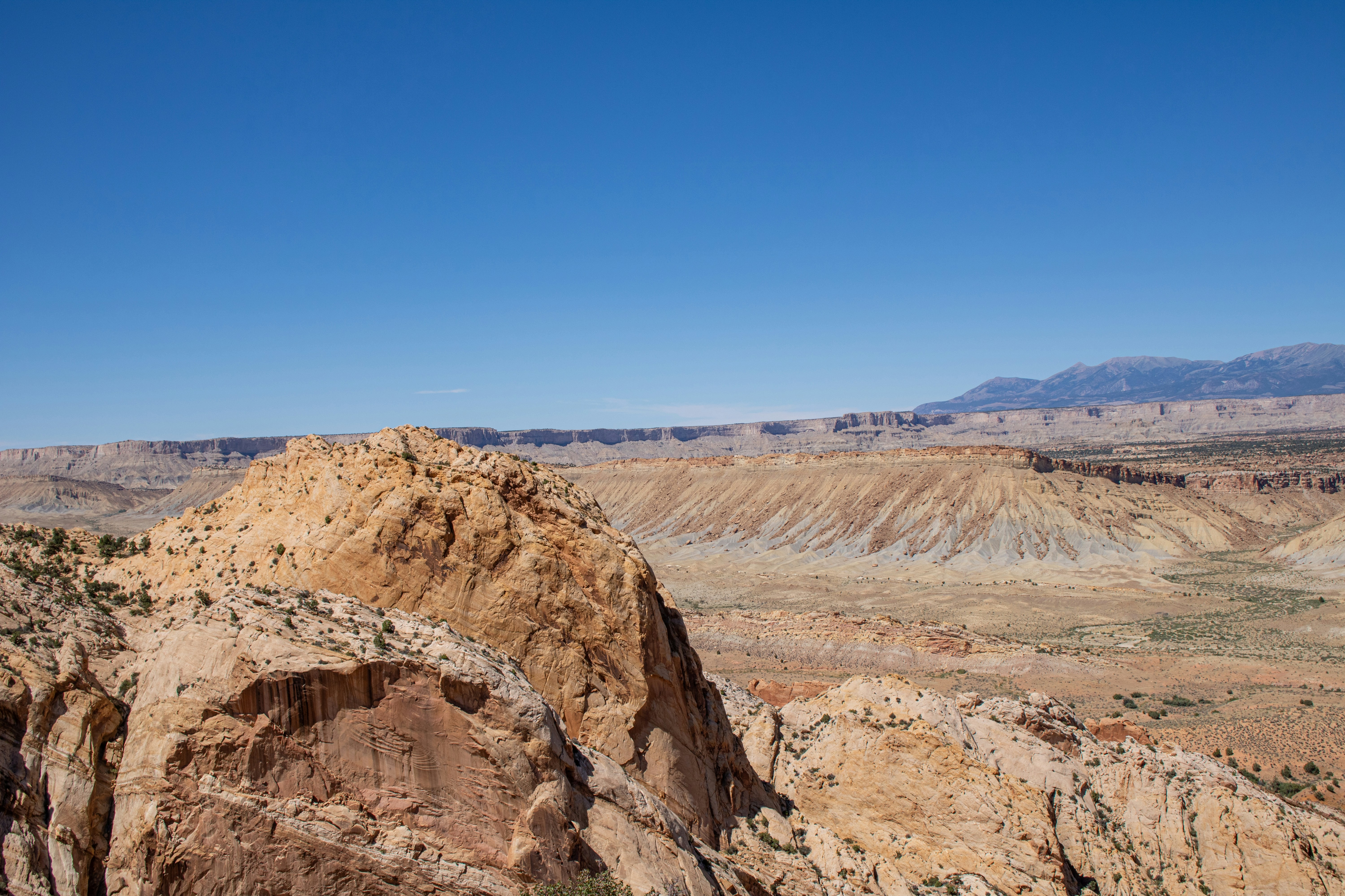 A rocky outcropping in the middle of a desert, The Burr Trail Switchbacks in Capitol Reef National Park are a thrilling series of steep, narrow turns that descend nearly 800 feet in just a mile. Carved into the rugged Waterpocket Fold, they connect the Burr Trail Road with the dramatic landscapes of Grand Staircase-Escalante National Monument. With towering red sandstone cliffs, expansive desert views, and geological wonders, the switchbacks are best suited for high-clearance vehicles. This remote, scenic route offers adventurous travelers a unique way to experience Utah’s breathtaking natural beauty.