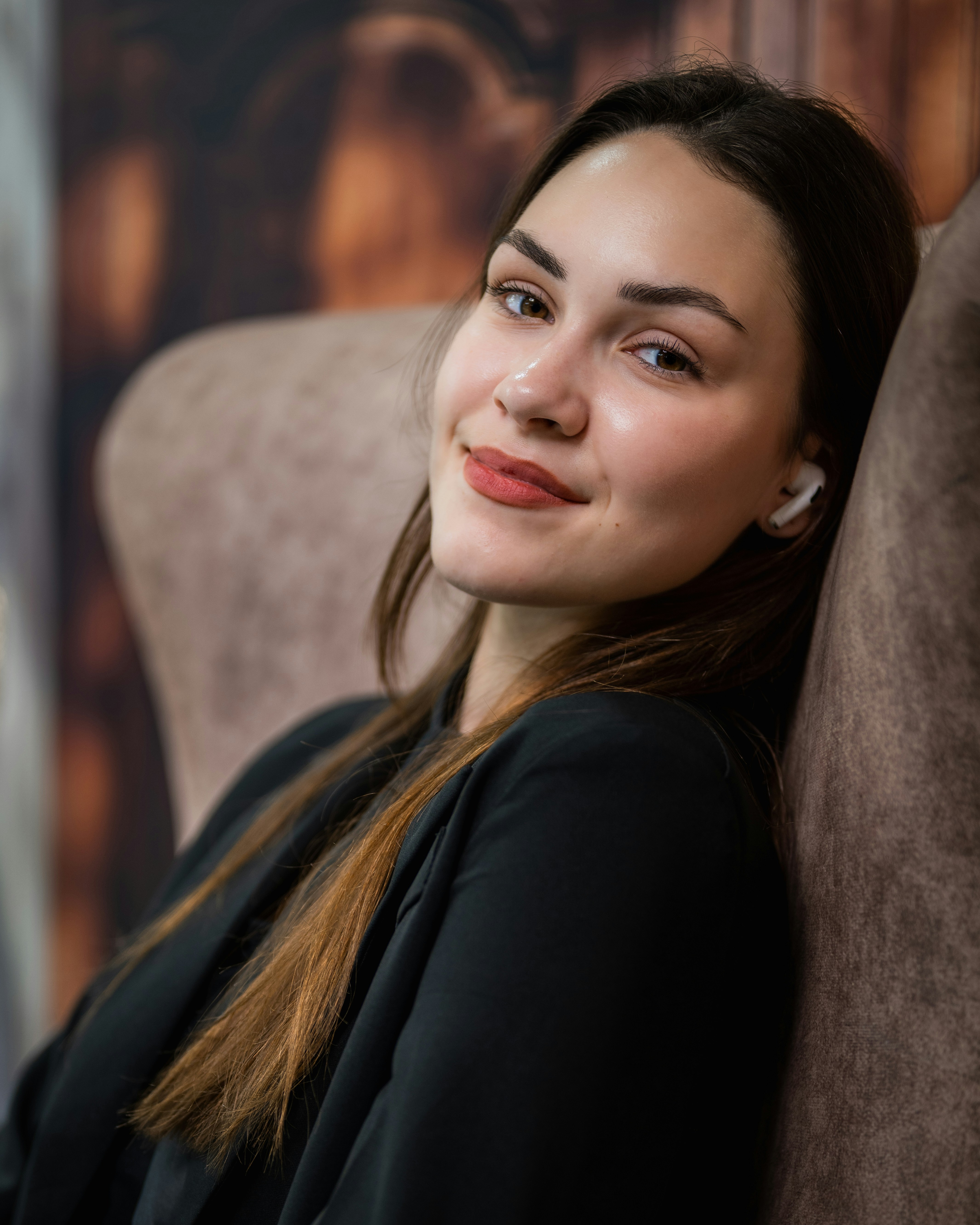 A woman sitting in a chair with her eyes closed